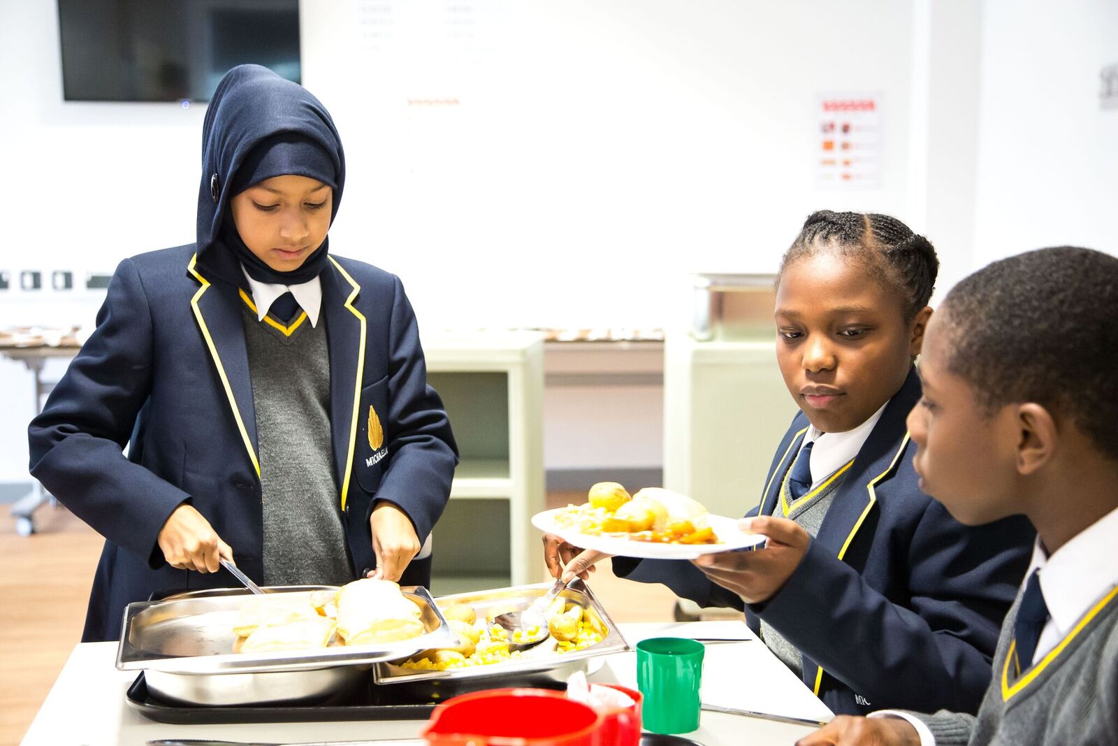 Pupils serve each other as part of Michaela's 'Family Lunch' system (Courtesy Michaela Community School)