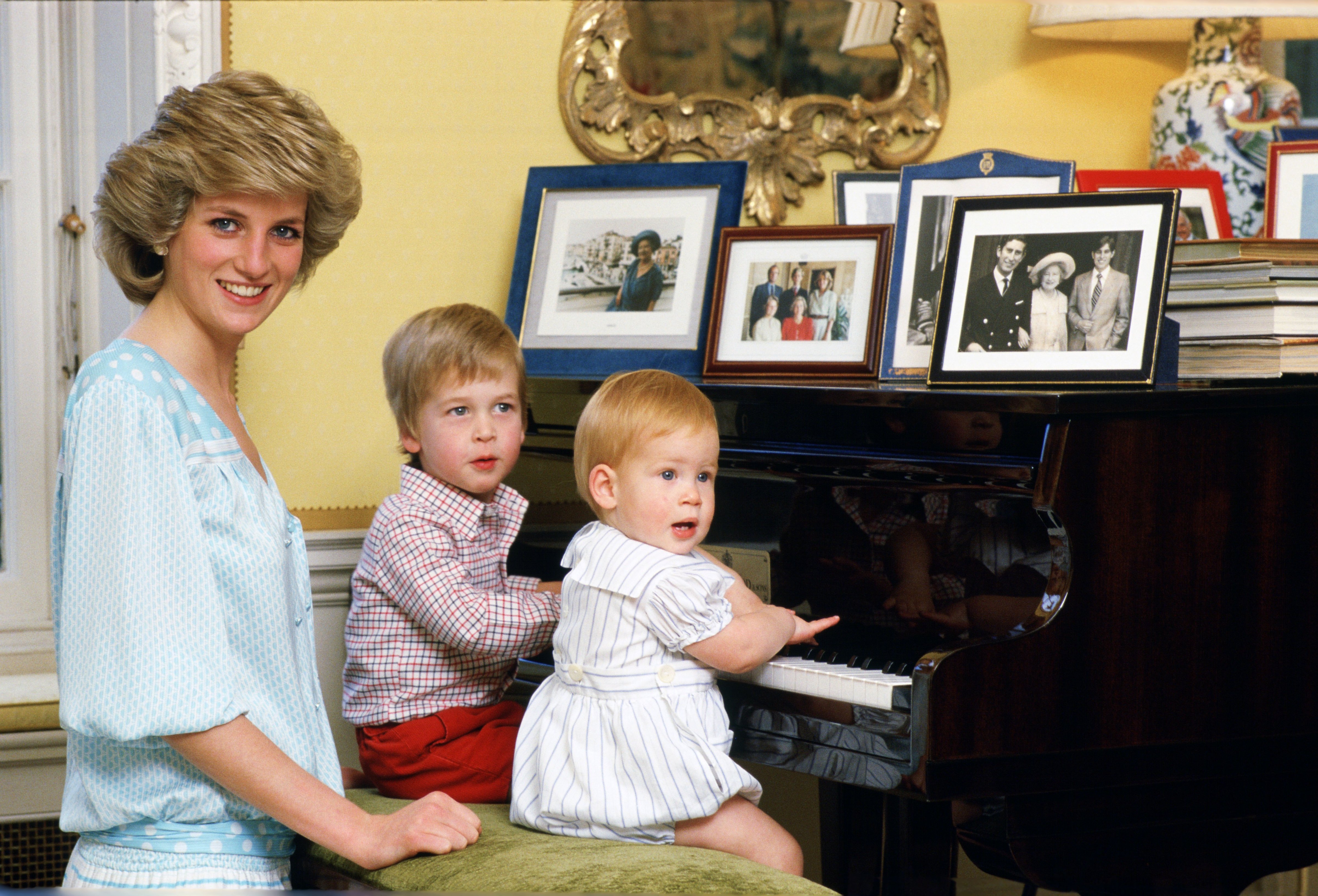 Diana, Princess of Wales with her sons, Prince William and Prince Harry, at the piano in Kensington Palace. (Tim Graham/Getty Images)