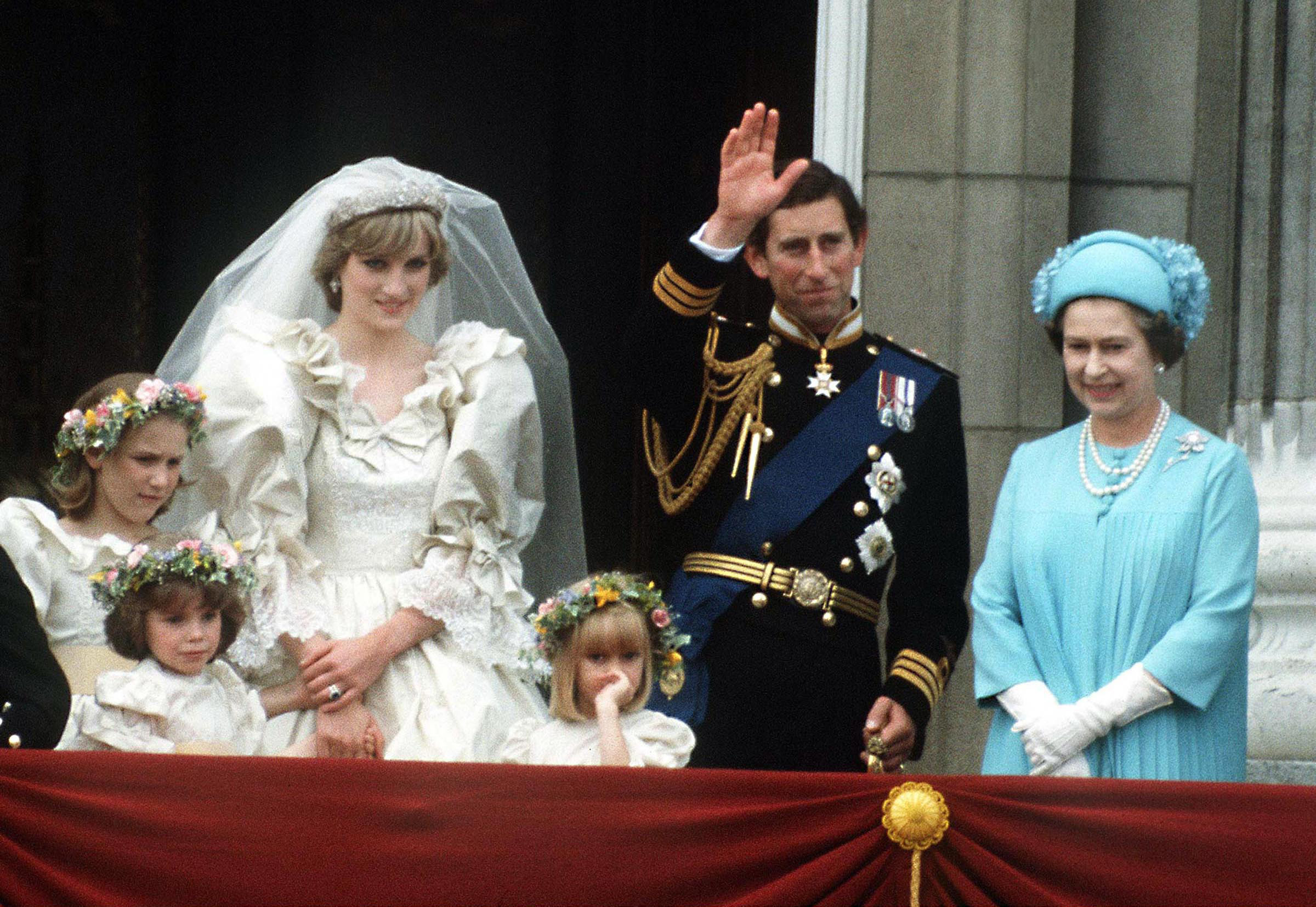 The Prince and Princess of Wales pose on the balcony of Buckingham Palace on their wedding day, with the Queen and some of the bridesmaids, 29th July 1981. (Princess Diana Archive—Getty Images)