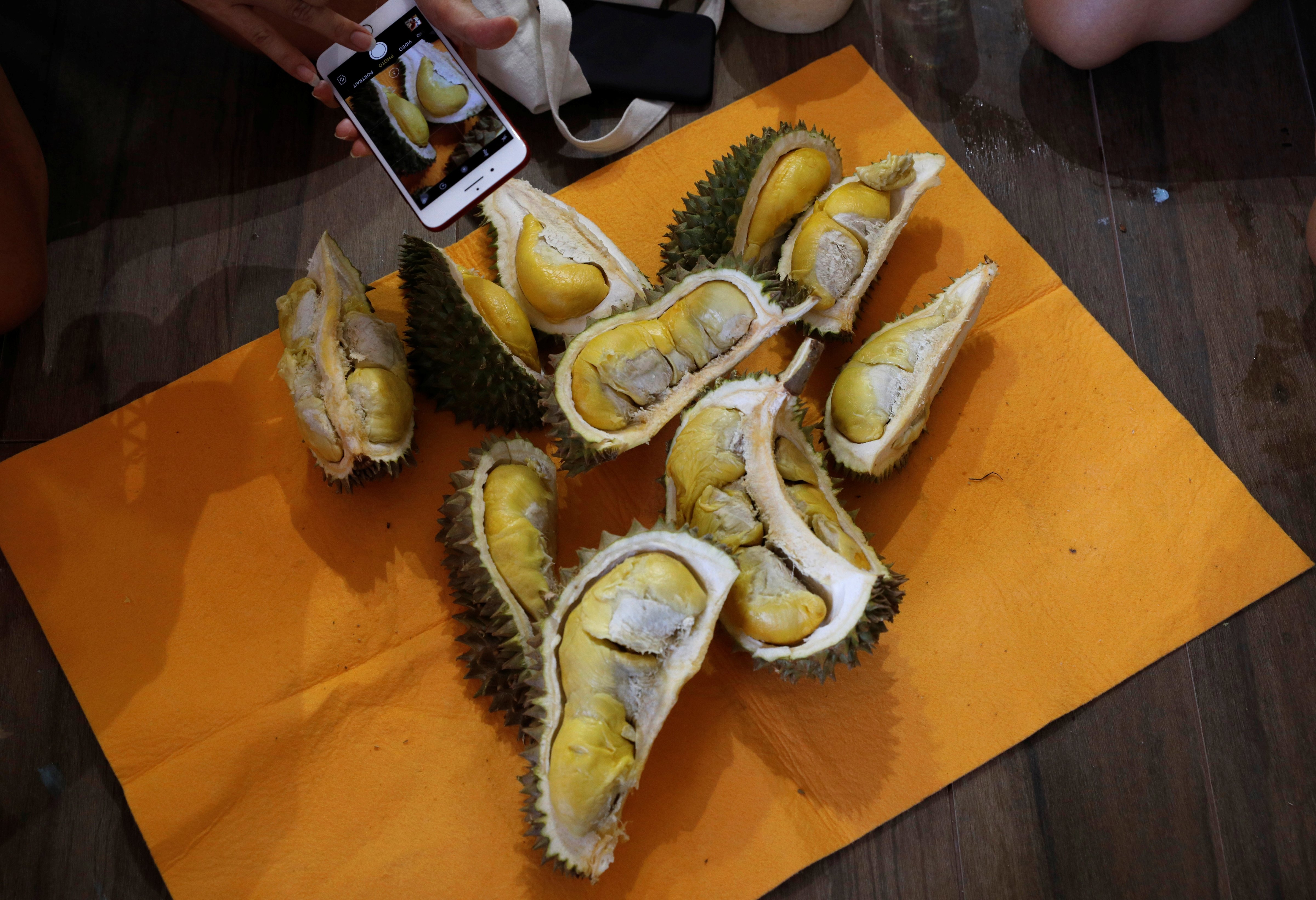 Participants take photos of durians after the Durian Run, a charity event, in Singapore on July 23, 2017. (Edgar Su&mdash;Reuters)