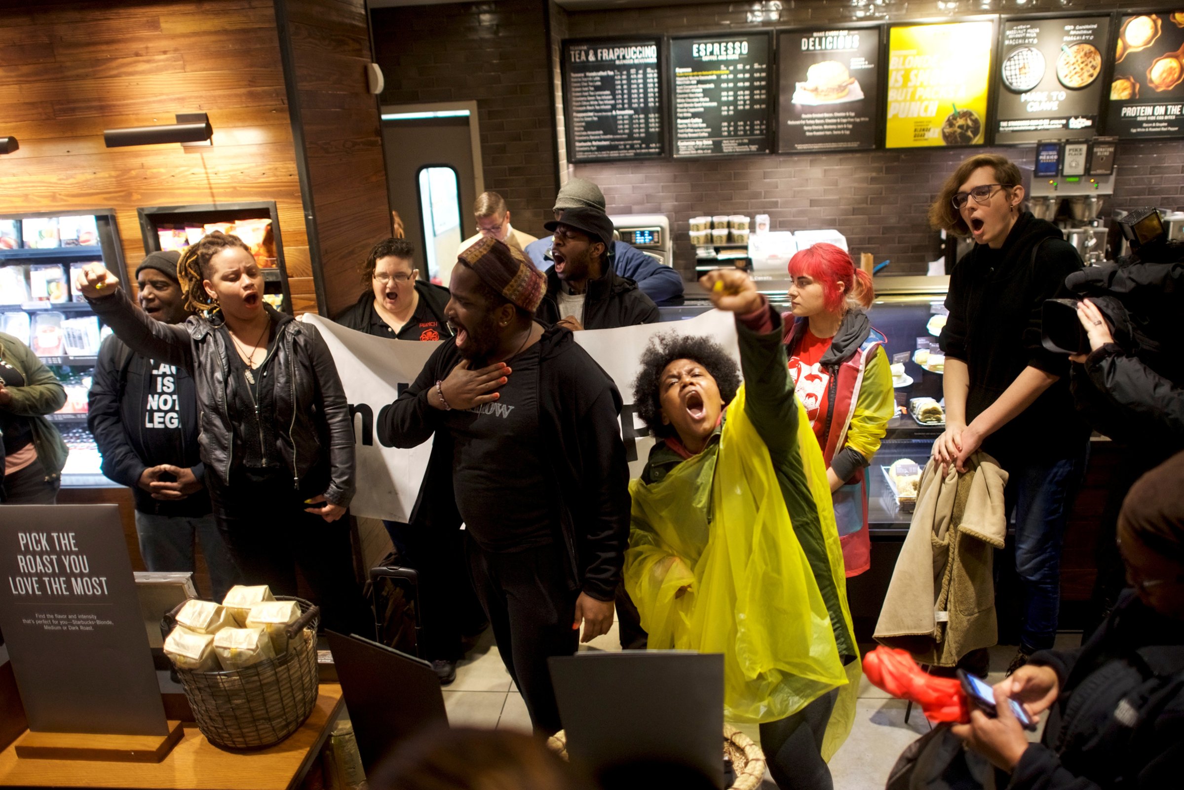 Protesters demonstrate inside a Center City Starbucks, where two black men were arrested, in Philadelphia