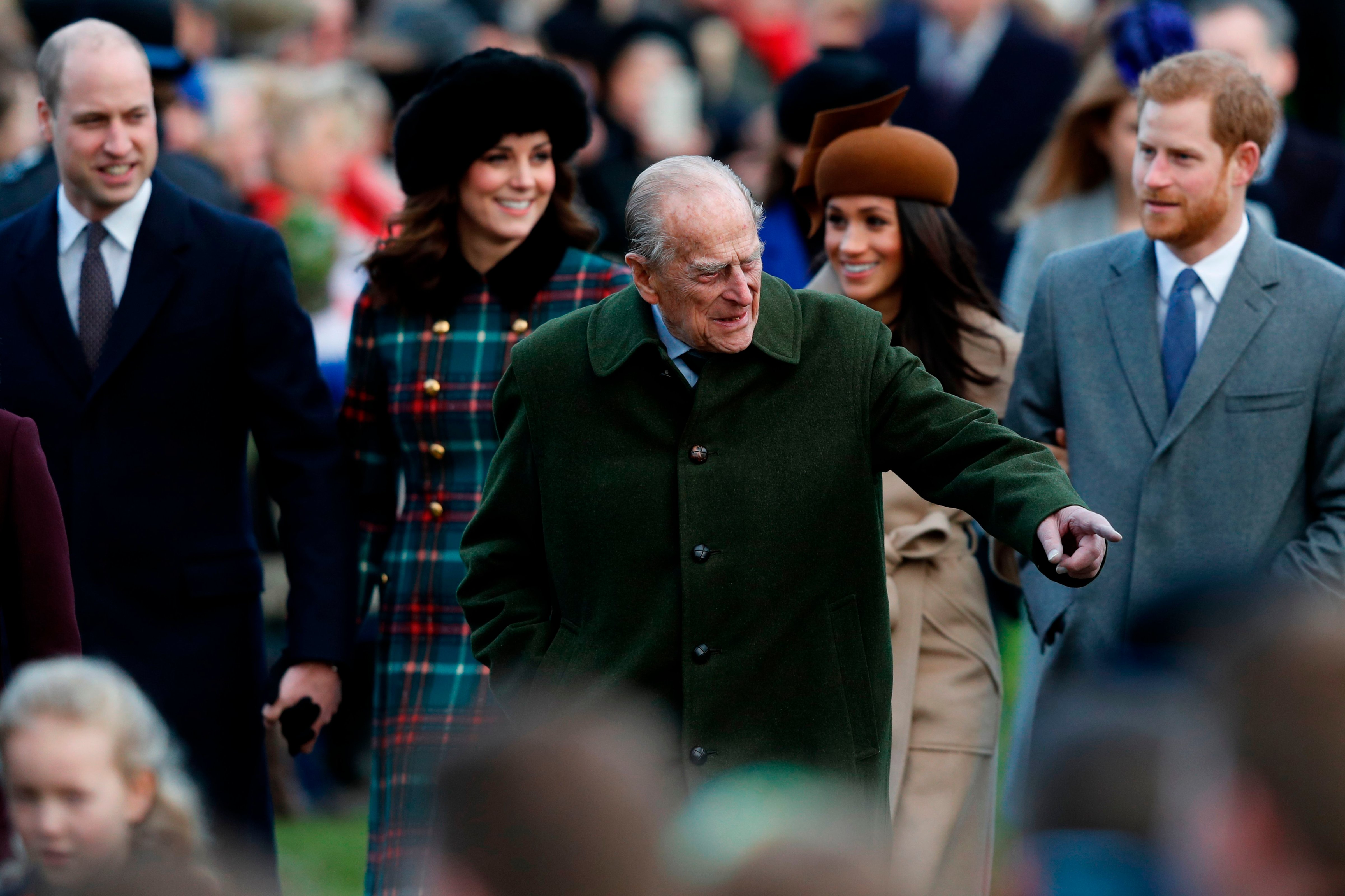 Britain's Prince Philip, Duke of Edinburgh (C) gestures as he is followed by (L-R) Britain's Prince William, Duke of Cambridge, Britain's Catherine, Duchess of Cambridge, US actress and fiancee of Britain's Prince Harry Meghan Markle and Britain's Prince Harry arriving to attend the Royal Family's traditional Christmas Day church service at St Mary Magdalene Church in Sandringham, Norfolk, eastern England, on December 25, 2017. (ADRIAN DENNIS—AFP/Getty Images)