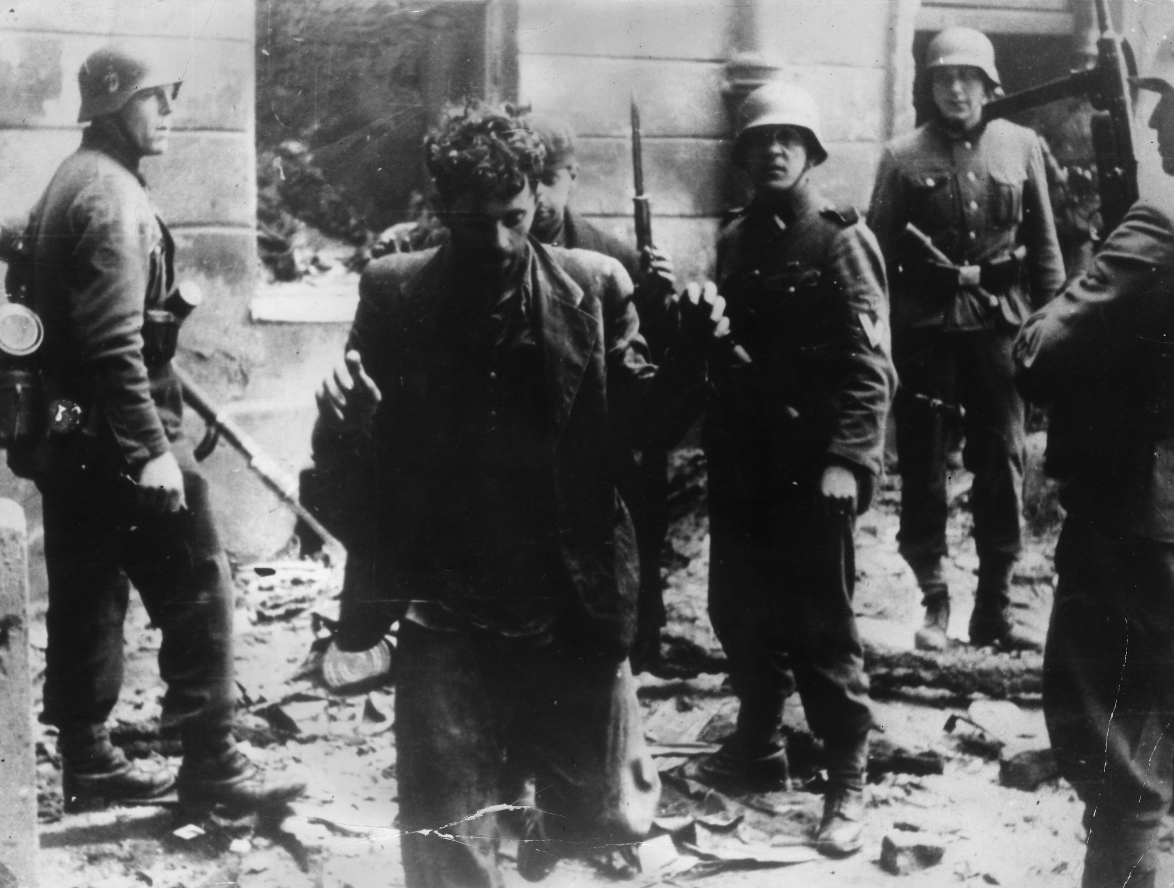 April 1943:  Two Jewish resistance fighters arrested by German troops during the Warsaw Ghetto Uprising. (Keystone/Getty Images)