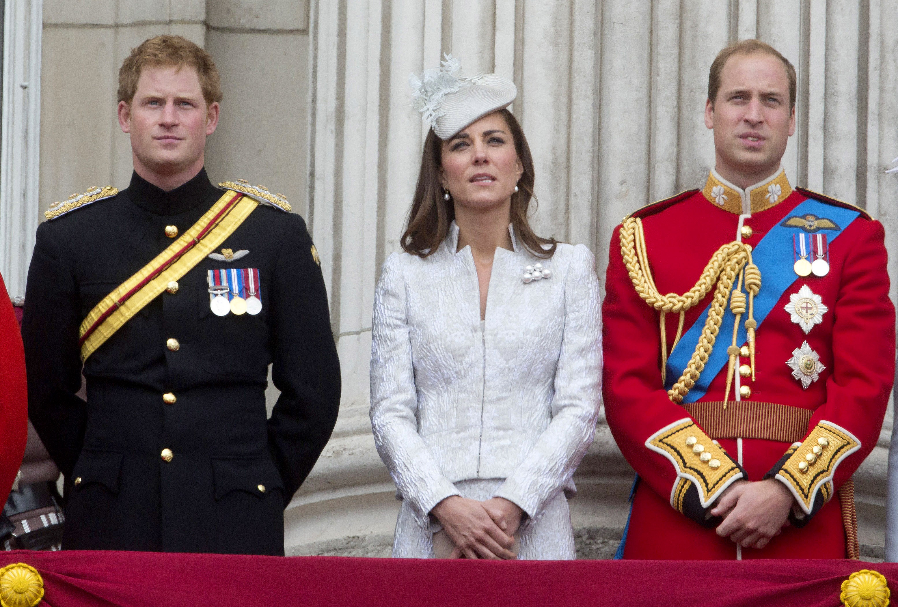 Prince Harry, Catherine Duchess of Cambridge and Prince William Duke of Cambridge stand on the balcony during Trooping the Colour at The Royal Horseguards on June 14, 2014 in London, England. (Julian Parker—UK Press via Getty Images)