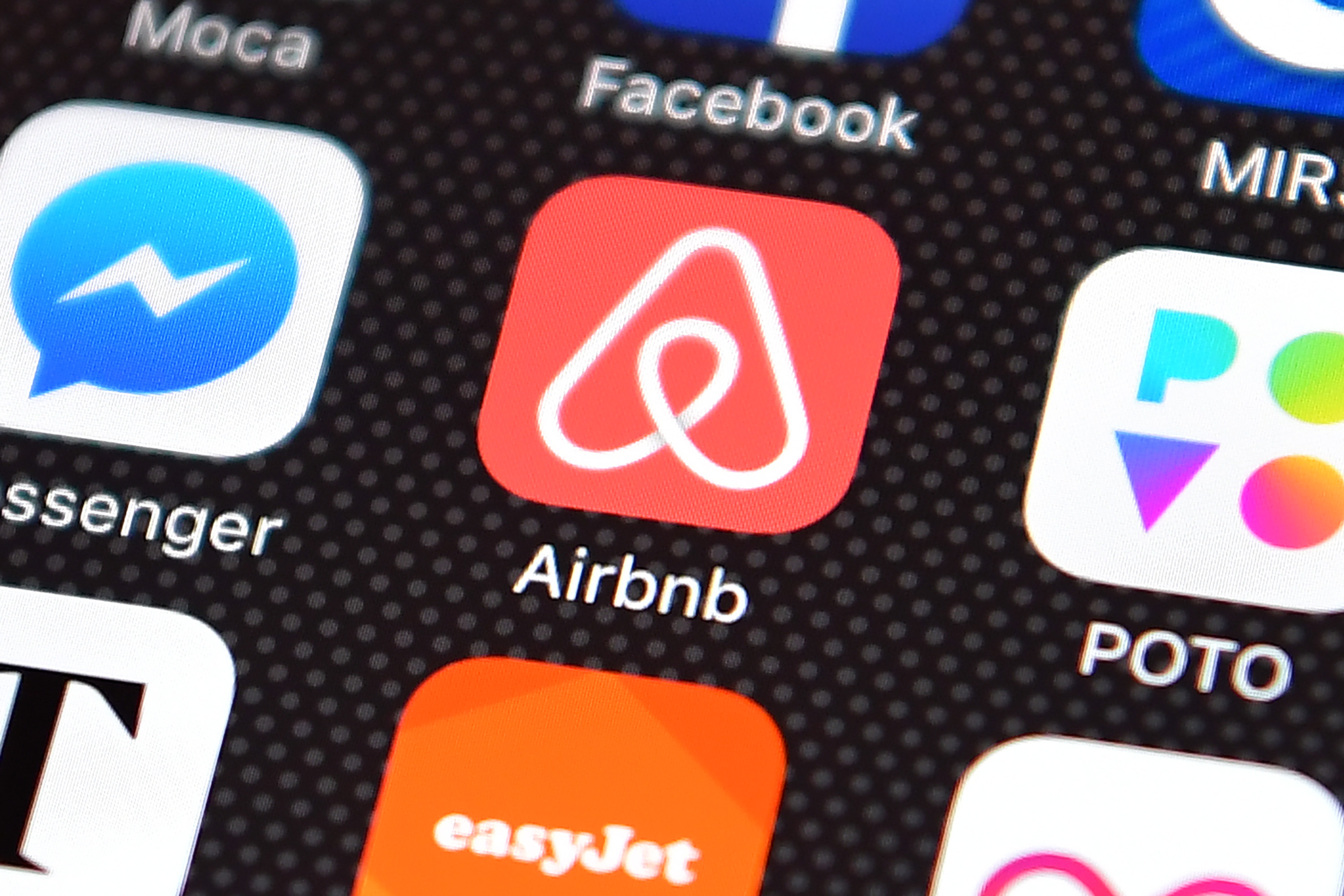 The Airbnb app logo is displayed on an iPhone. (Carl Court&mdash;Getty Images)