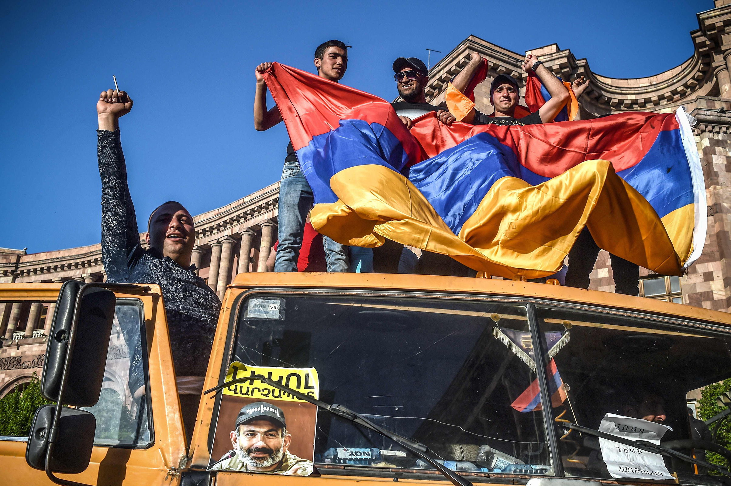 Protesters in Yerevan on May 2 wave the Armenian flag from a truck displaying a photograph of opposition leader Nikol Pashinyan, who was appointed interim Prime Minister days later (SERGEI GAPON—AFP/Getty Images)