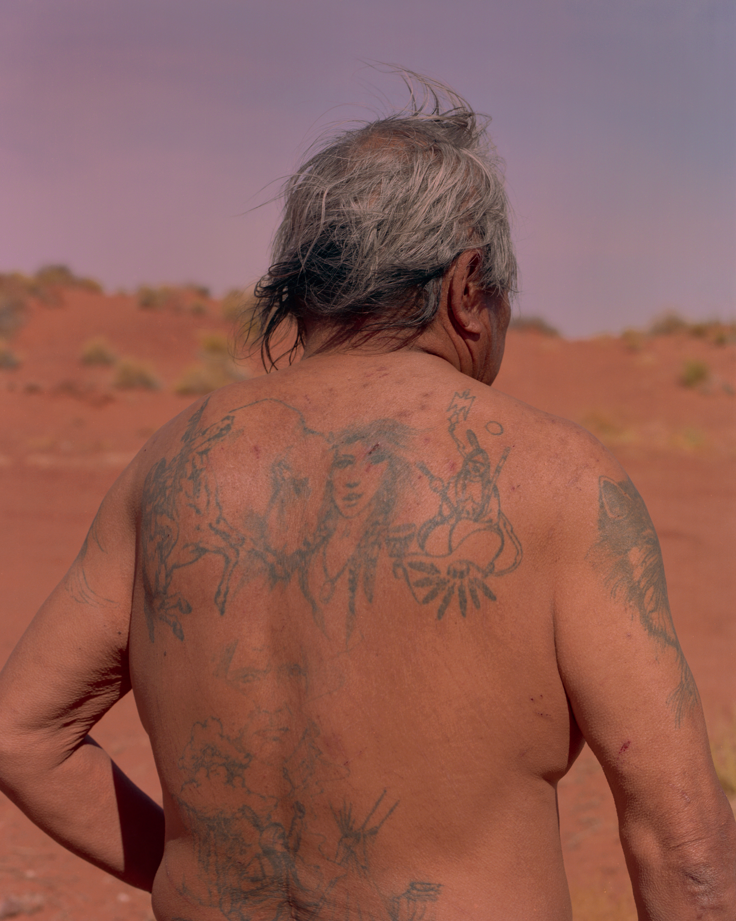 Wilson Collins is pictured at his home in Monument Valley. The tattoos covering his body include traditional Navajo imagery. Collins struggles with alcoholism, a common problem on reservations that is now being addressed by many tribes. He lives in a trailer and spends most of his days with his younger brother, who sells Navajo arts and crafts. (Ryan Shorosky for TIME)