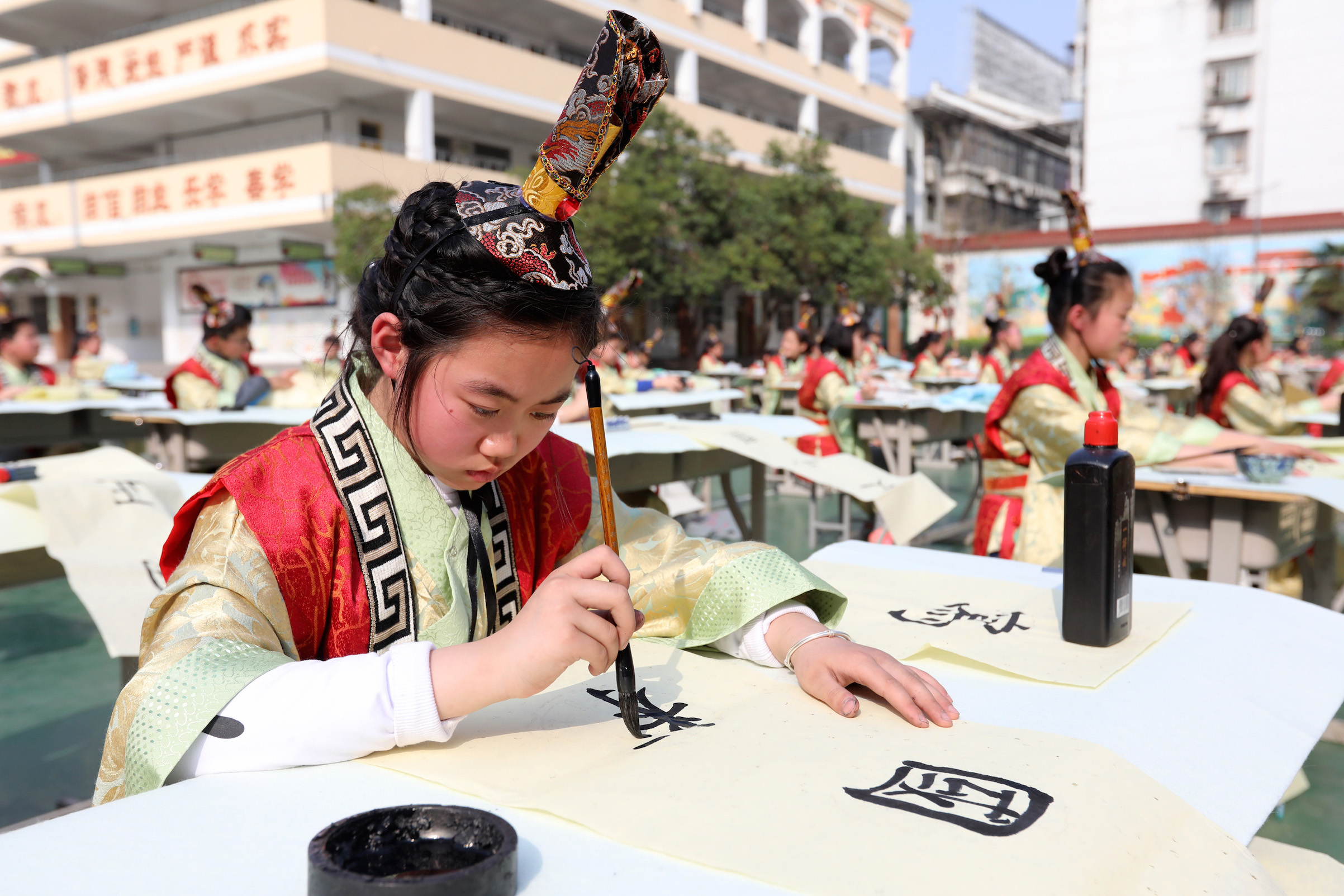 Students of Huaibei City Gucheng Road Primary School attend a calligraphy competition on March 30, 2018, in Huaibei, Anhui Province of China. (VCG / Getty Images)