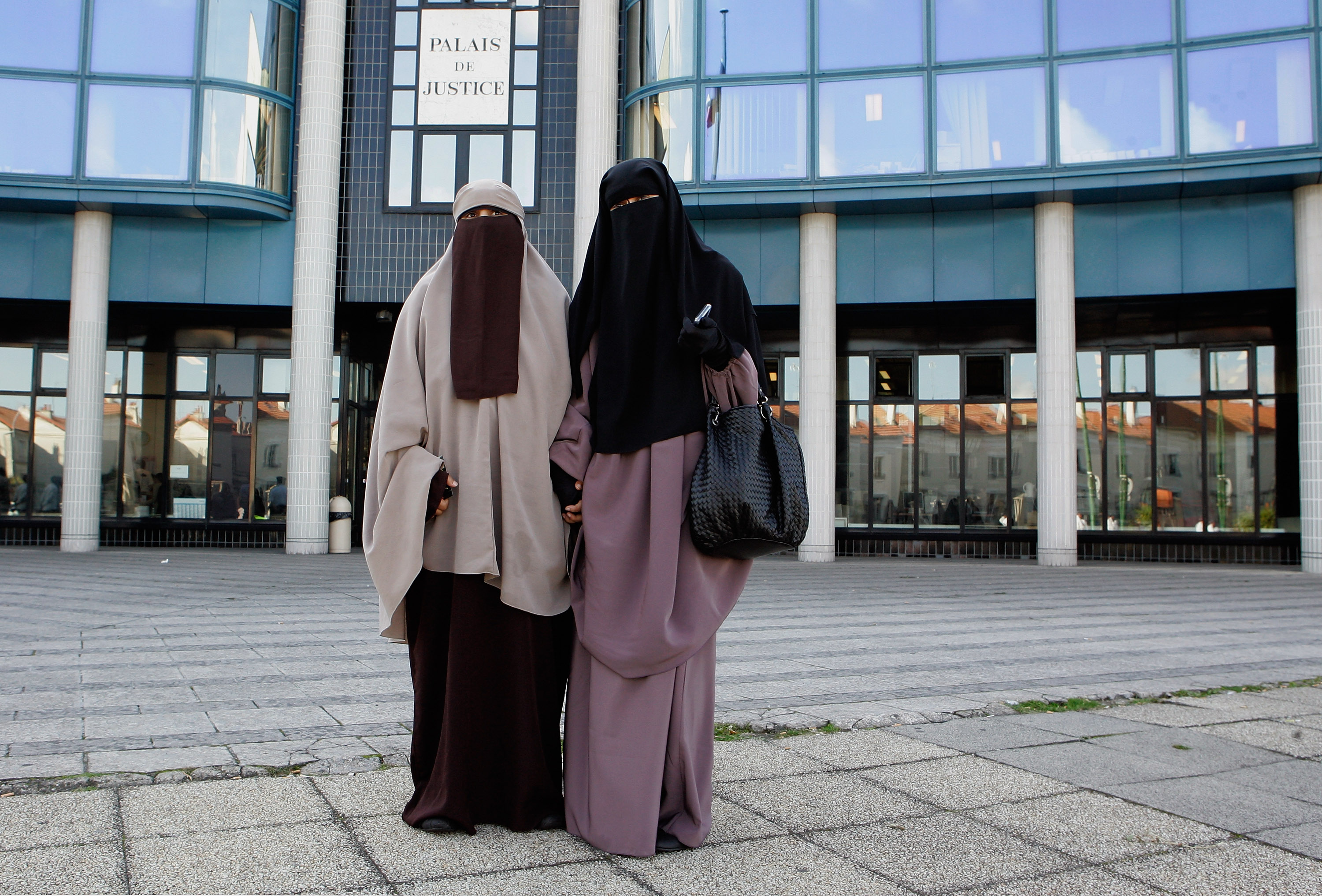 Hind Ahmas, 32, (R) stands with Kenza Drider, 32, as she leaves the court after being convicted as the first woman wearing a niqab after France's nationwide ban on the wearing of face veils on Sept. 22, 2011 in Meaux, France. (Franck Prevel—Getty Images)