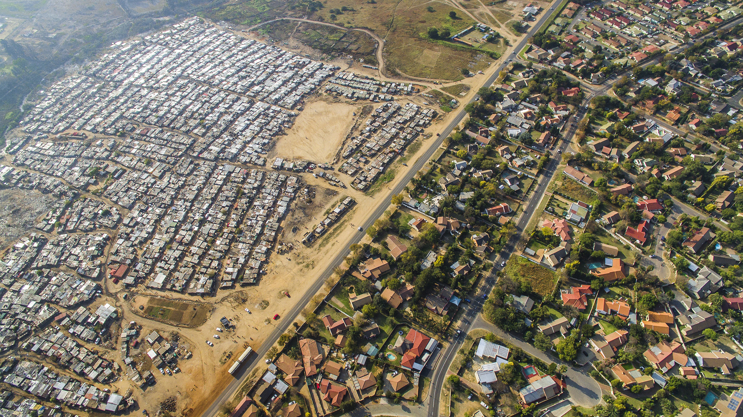Inequality is found around the globe, but the World Bank says South Africa qualifies as the starkest example. For a vivid perspective on it, Johnny Miller of the Unequal Scenes Project sent a drone over northwest Johannesburg. On the left is Kya Sands, a shack city that is home to many economic migrants who arrived from other African nations. Across the road is Bloubusrand, a middle-class suburb known for its diverse mix of residents. (Johnny Miller)