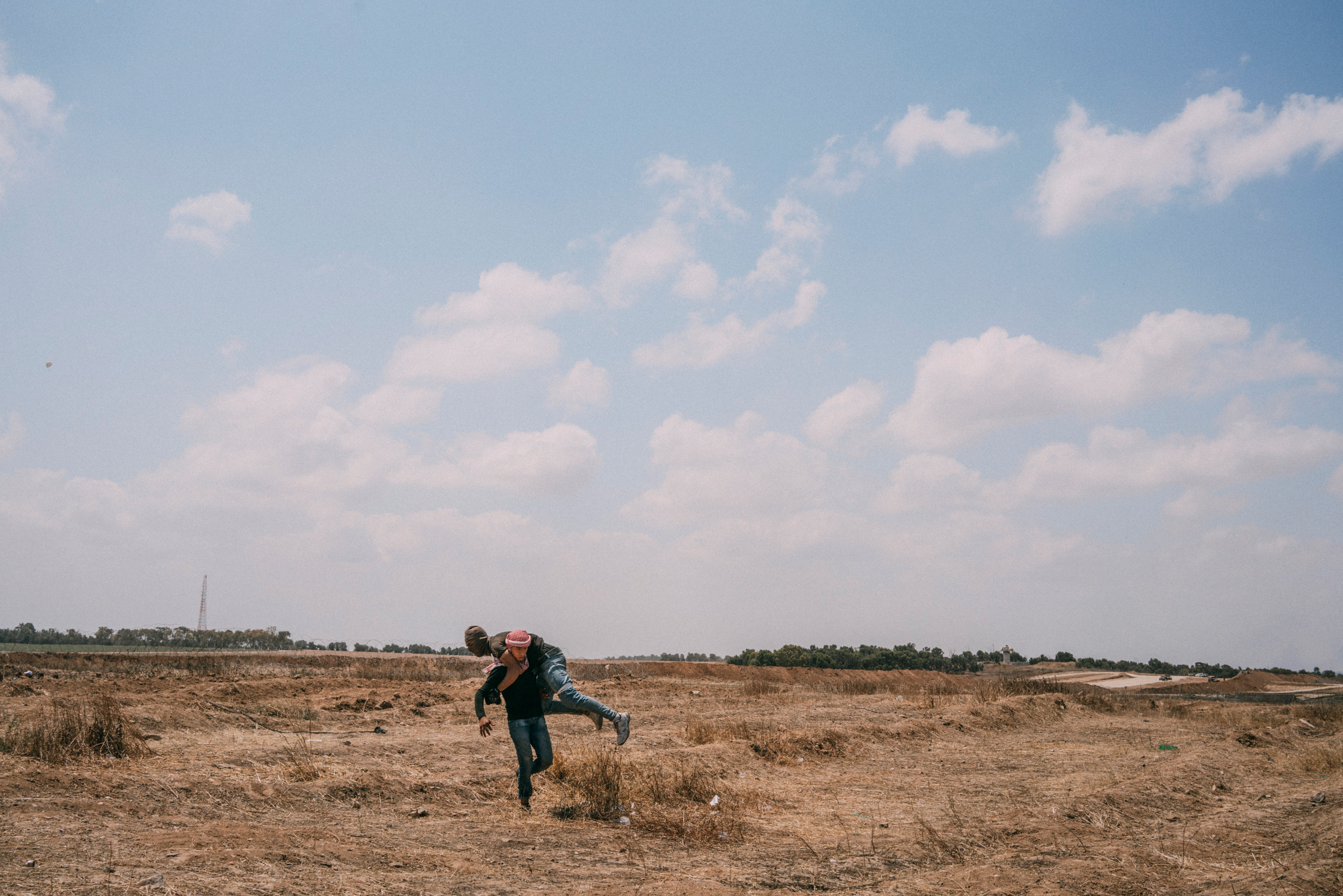 A wounded demonstrator is carried away during the protest along the Gaza-Israel border. (Emanuele Satolli for TIME)