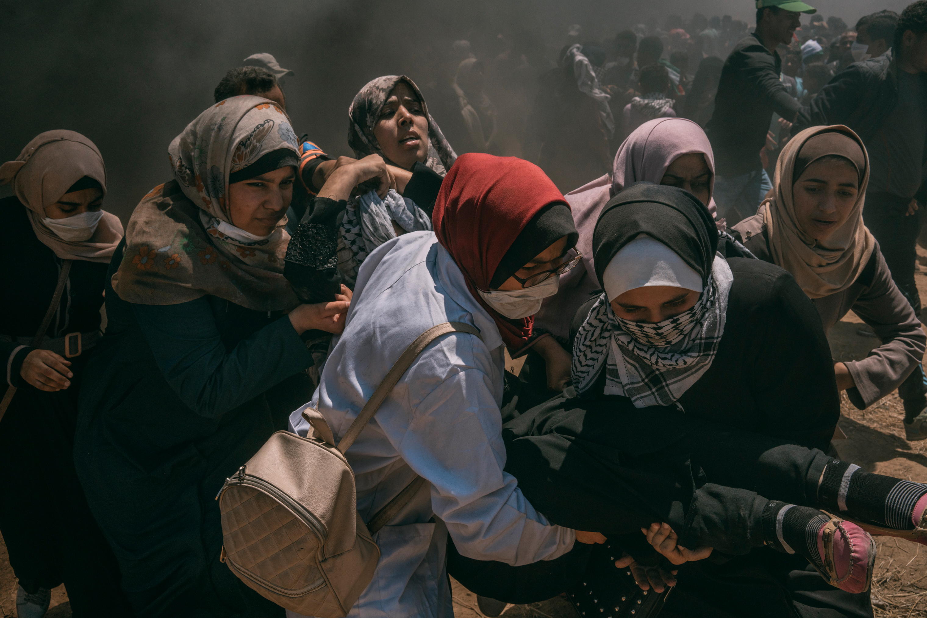 A wounded woman is evacuated by other women after she was injured in the head during the protest along the Gaza-Israel border. (Emanuele Satolli for TIME)