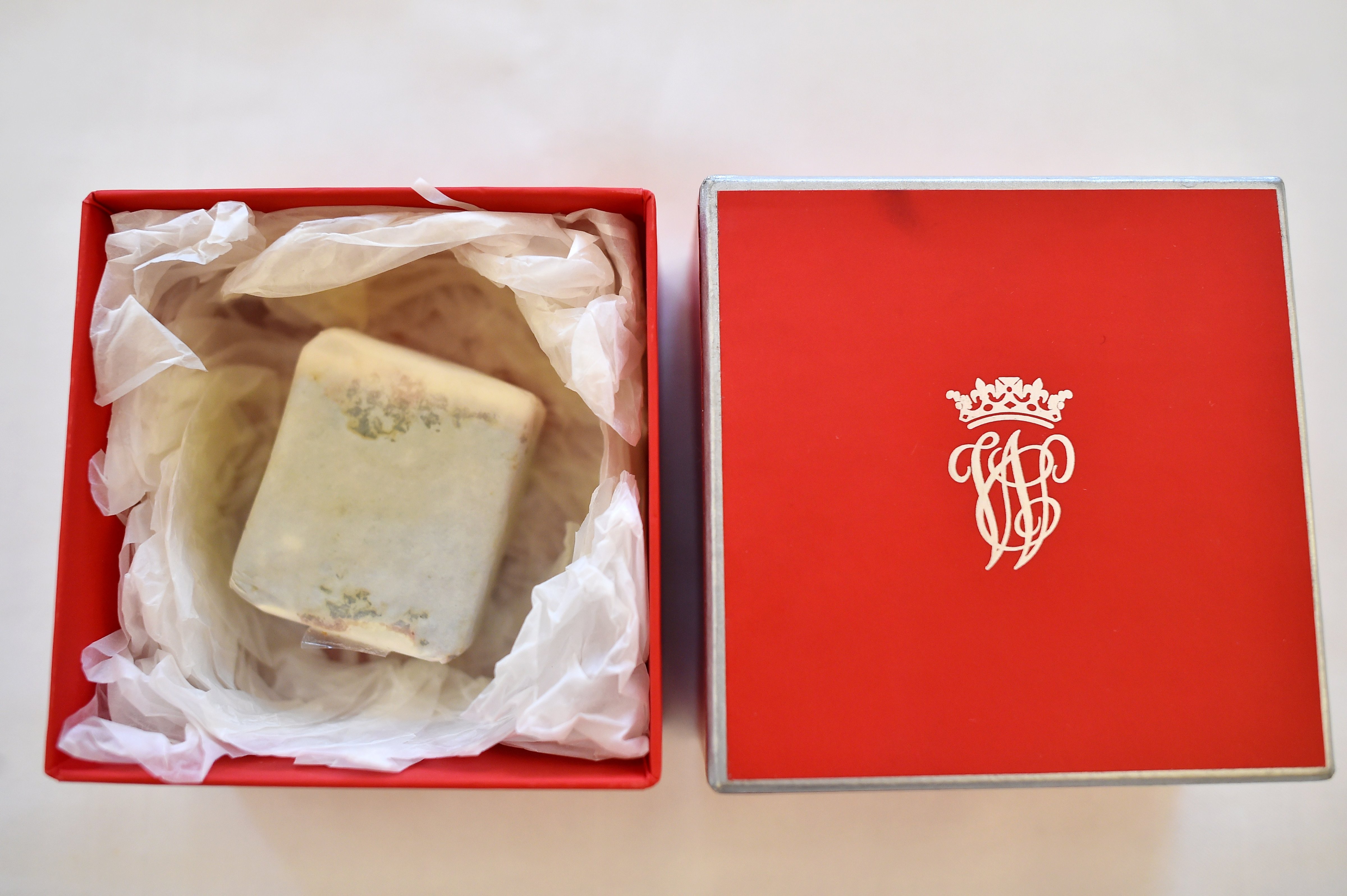 A boxed slice of wedding cake, from the British Royal wedding of Prince William, Duke of Cambridge to Britain's Catherine, Duchess of Cambridge, collected by Leonard Massey, the former first chauffeur to Britain's Queen Elizabeth II, is displayed at the Stafford Hotel in London on June 5, 2015, ahead of its auction in Beverly Hills, US, on June 27. (BEN STANSALL—AFP/Getty Images)
