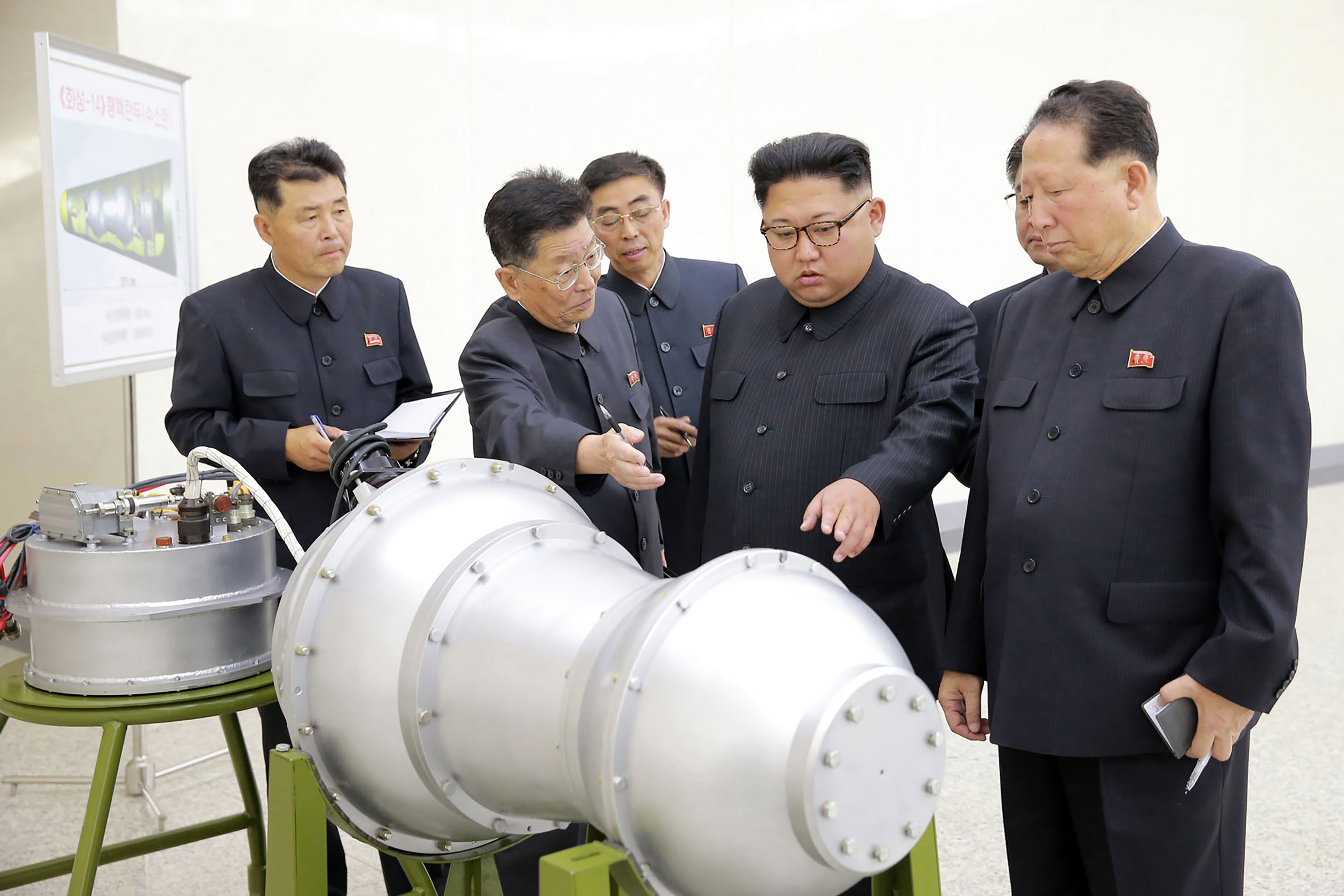 This undated picture released by North Korea's official Korean Central News Agency (KCNA) on September 3, 2017 shows North Korean leader Kim Jong-Un looking at a metal casing with two bulges at an undisclosed location. (AFP/Getty Images)