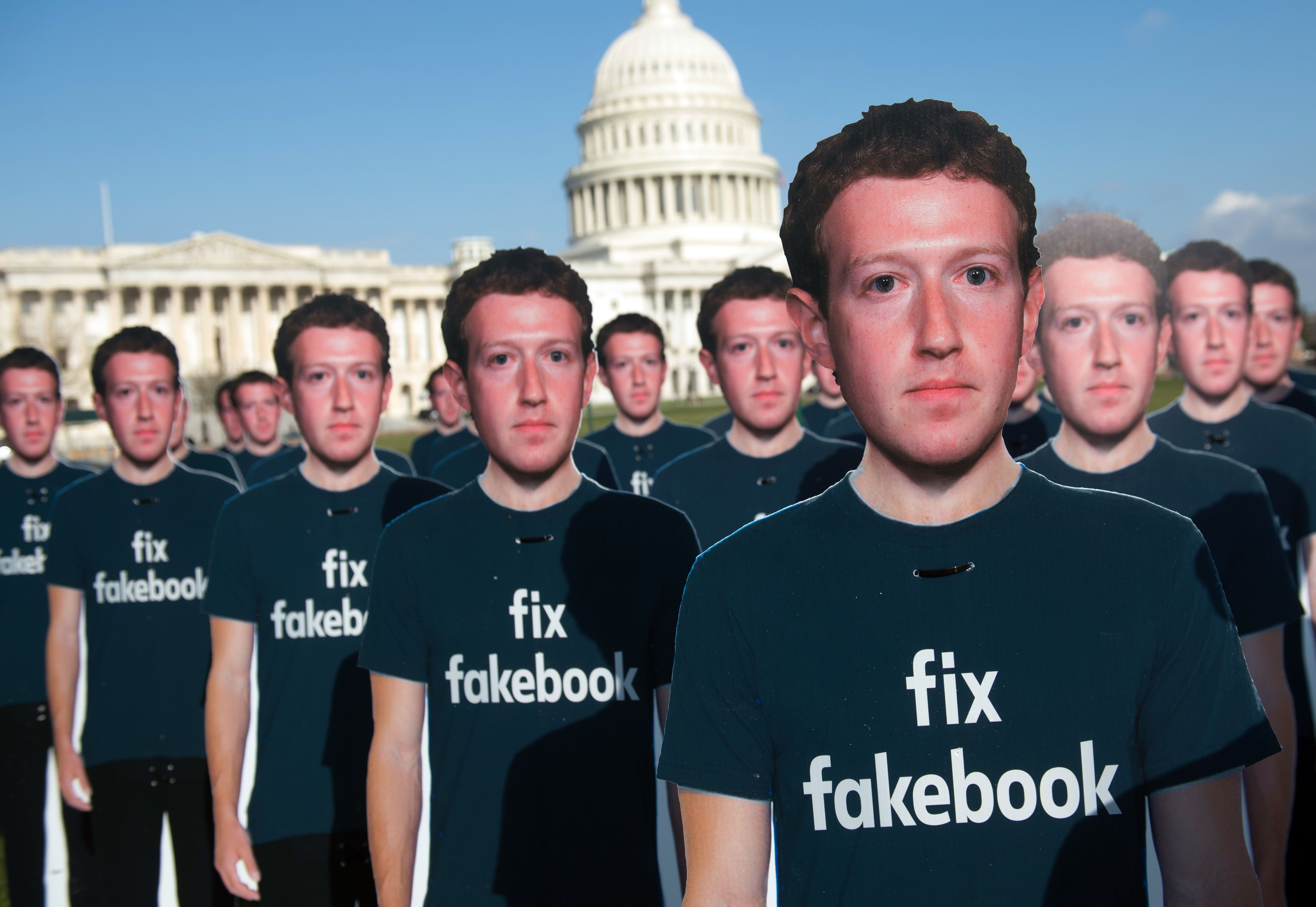 One hundred cardboard cutouts of Facebook founder and CEO Mark Zuckerberg stand outside the U.S. Capitol in Washington, DC, April 10, 2018. Advocacy group Avaaz is calling attention to what the groups says are hundreds of millions of fake accounts still spreading disinformation on Facebook. (Saul Loeb—AFP/Getty Images)