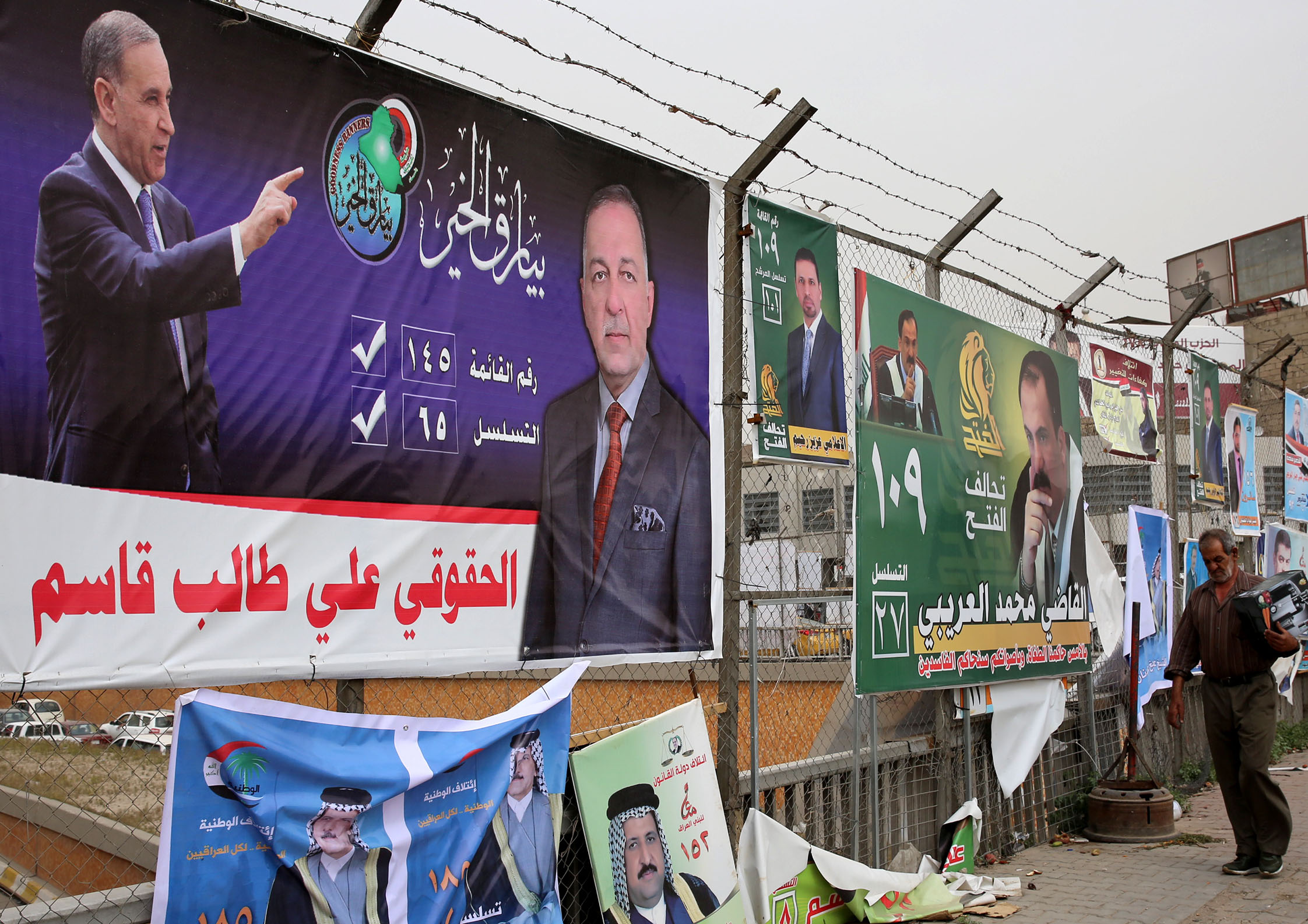 Posters of candidates in Iraq's upcoming parliamentary elections are seen with Arabic slogans in the streets of Baghdad on May 8, 2018. (Sabah Arar—AFP/Getty Images)