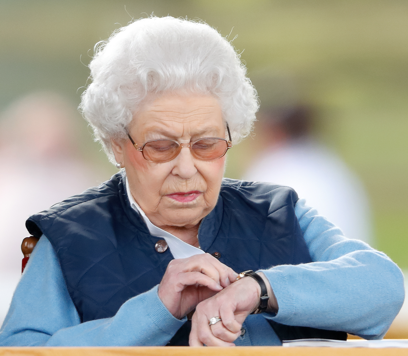 The Queen consults her wristpiece during the event. (Photo by Max Mumby/Indigo/Getty Images (Max Mumby/Indigo—Getty Images)