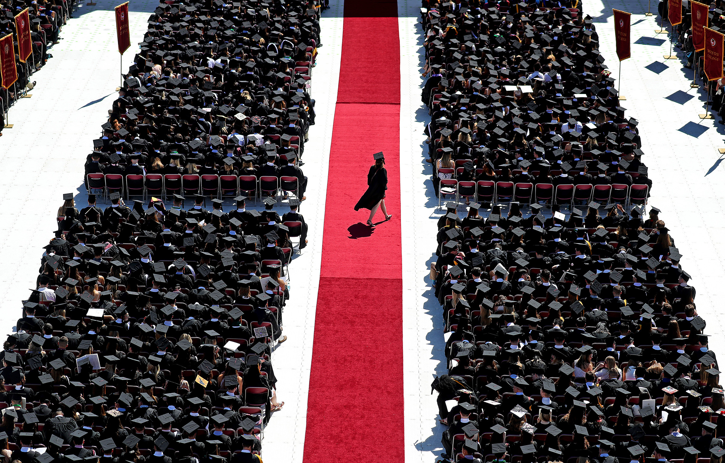 A graduate crosses the red carpet during the Boston College commencement at Alumni Stadium in Boston on May 21, 2018 (David L. Ryan—Getty Images)