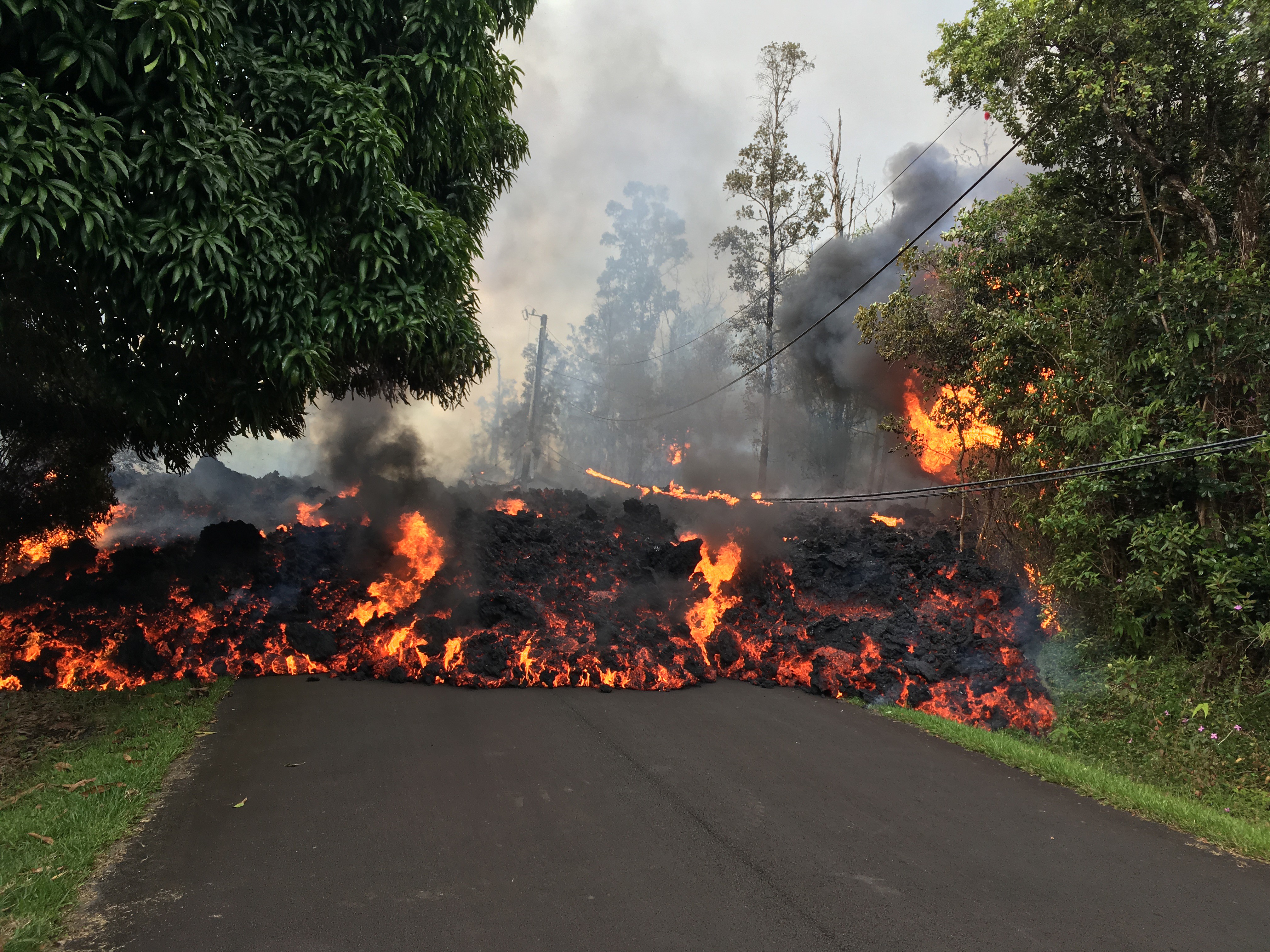 Lava flows from the crater of Kilauea volcano as dozens of structures, including at least nine homes, have been destroyed by scorching lava flows following a massive volcano eruption on Hawaii's Big Island, USA on May 6, 2018. Hawaii's Kilauea volcano erupted Thursday triggering a series of earthquakes that have continued to rattle the island as burning blood-red lava spewed hundreds of feet in the air from cracks in the ground. The strongest earthquakes were felt Friday when a 5.6-magnitude temblor was followed an hour later by a 6.9-magnitude earthquake, according to the U.S. Geological Survey (USGS). (Anadolu Agency—Getty Images)