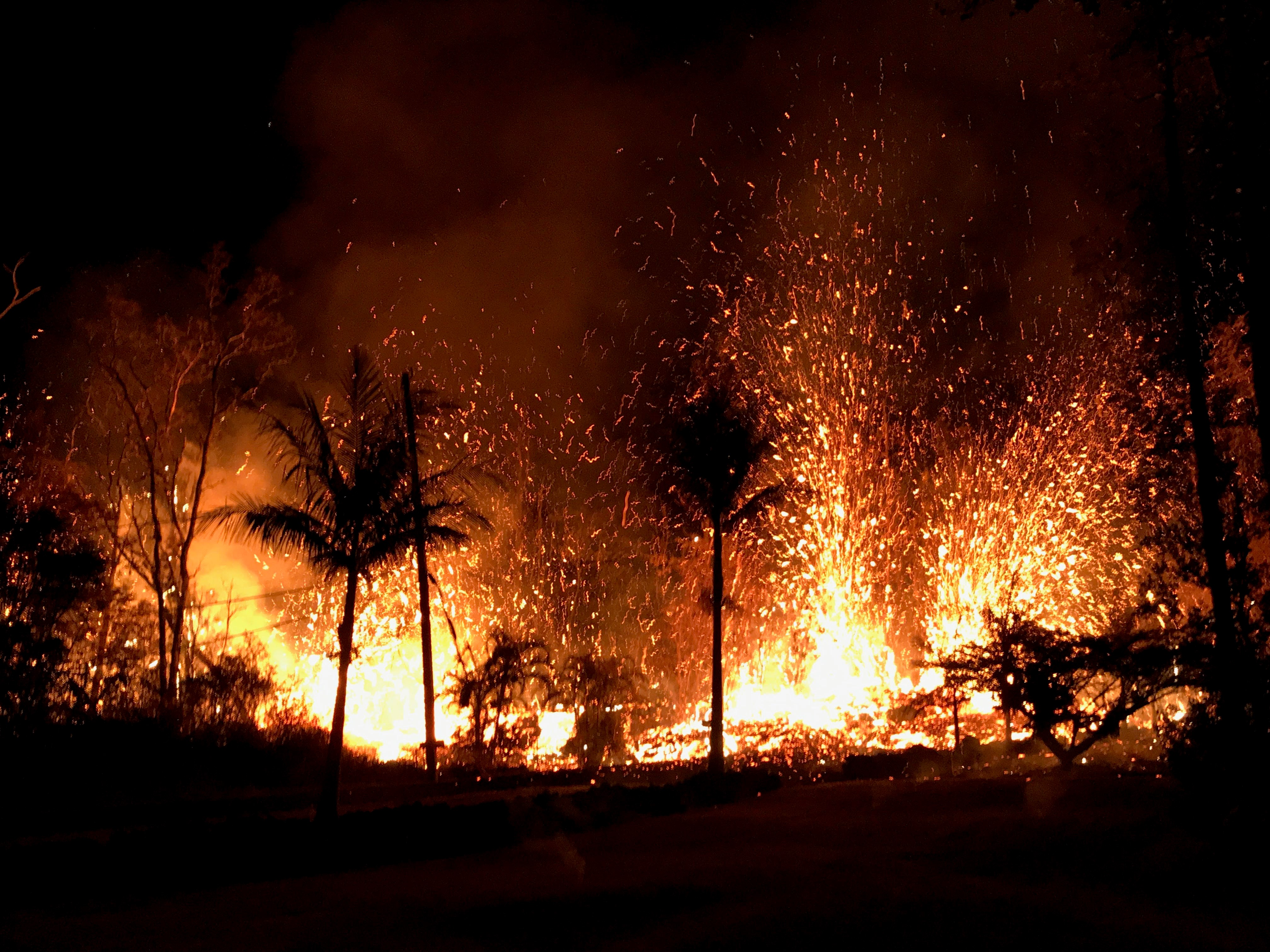 Fire breaks out at the forest as dozens of structures, including at least nine homes, have been destroyed by scorching lava flows following a massive volcano eruption on Hawaii's Big Island, USA on May 8, 2018. Hawaii's Kilauea volcano erupted Thursday triggering a series of earthquakes that have continued to rattle the island as burning blood-red lava spewed hundreds of feet in the air from cracks in the ground. The strongest earthquakes were felt Friday when a 5.6-magnitude temblor was followed an hour later by a 6.9-magnitude earthquake, according to the U.S. Geological Survey (USGS). (Anadolu Agency—Getty Images)