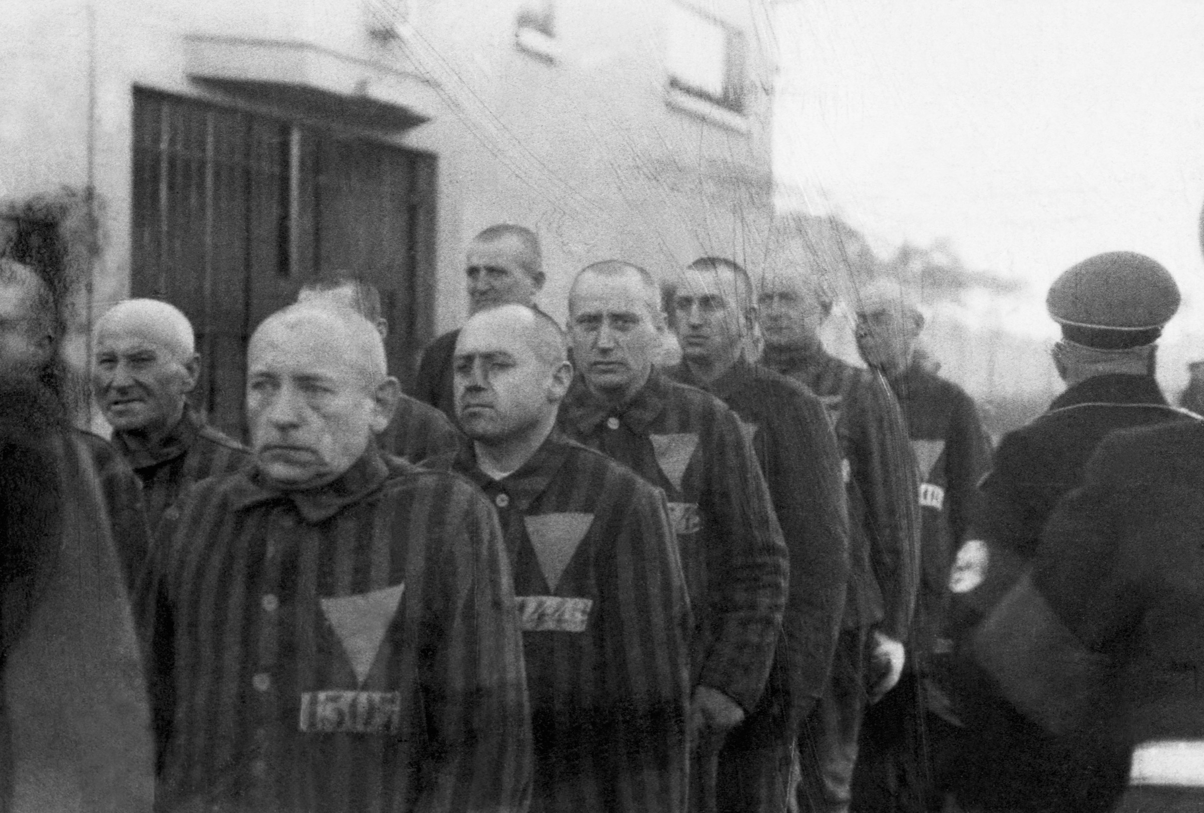 Prisoners wearing pink triangles on their uniforms are marched outdoors by Nazi guards at the Sachsenhausen concentration camp in Germany on Dec. 19, 1938. (CORBIS/Corbis—Getty Images)