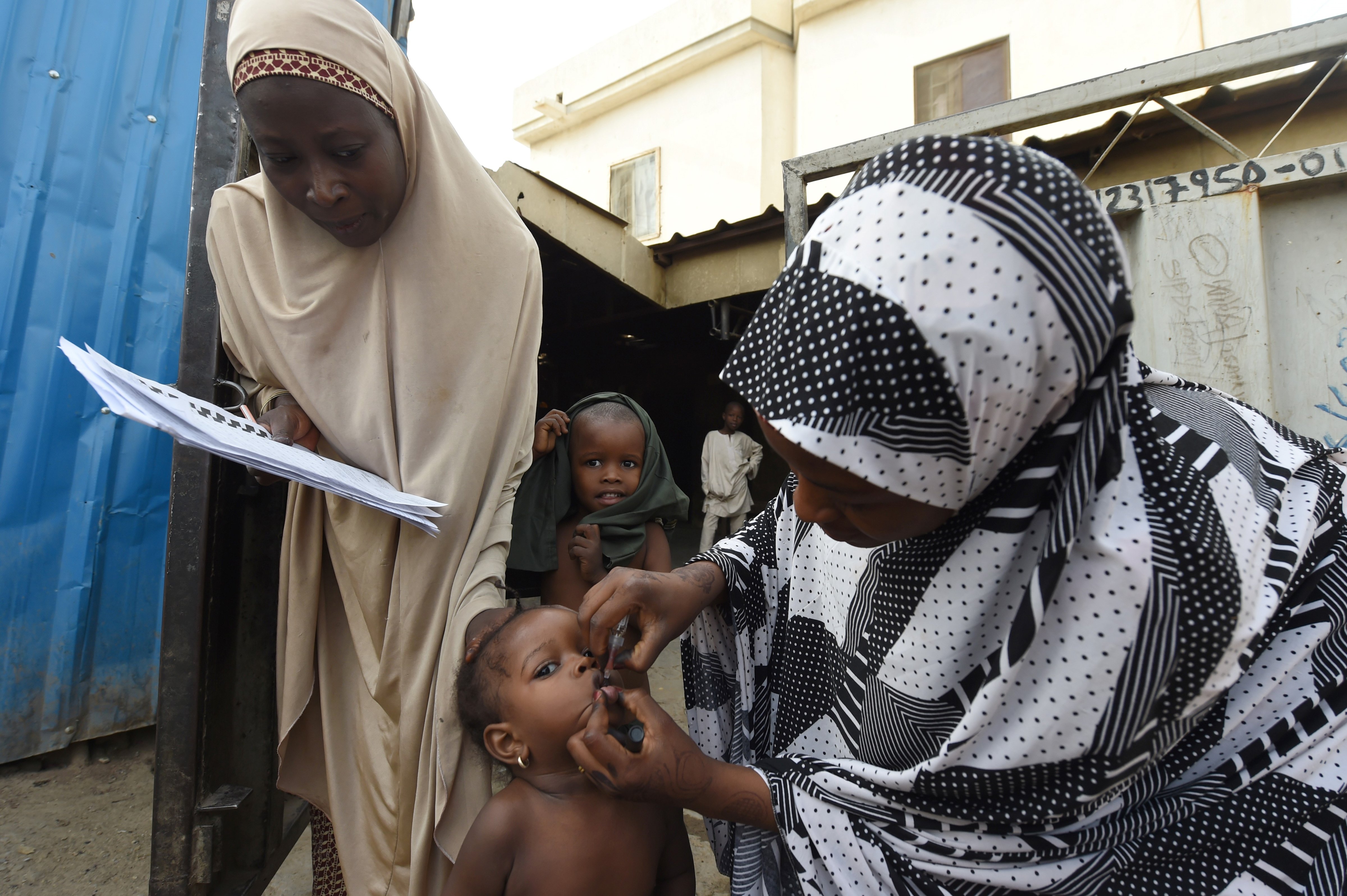 Health worker tries to immunise a child during vaccination campaign against polio at Hotoro-Kudu, Nassarawa district of Kano in northwest Nigeria, on April 22, 2017 (PIUS UTOMI EKPEI -AFP/Getty Images)
