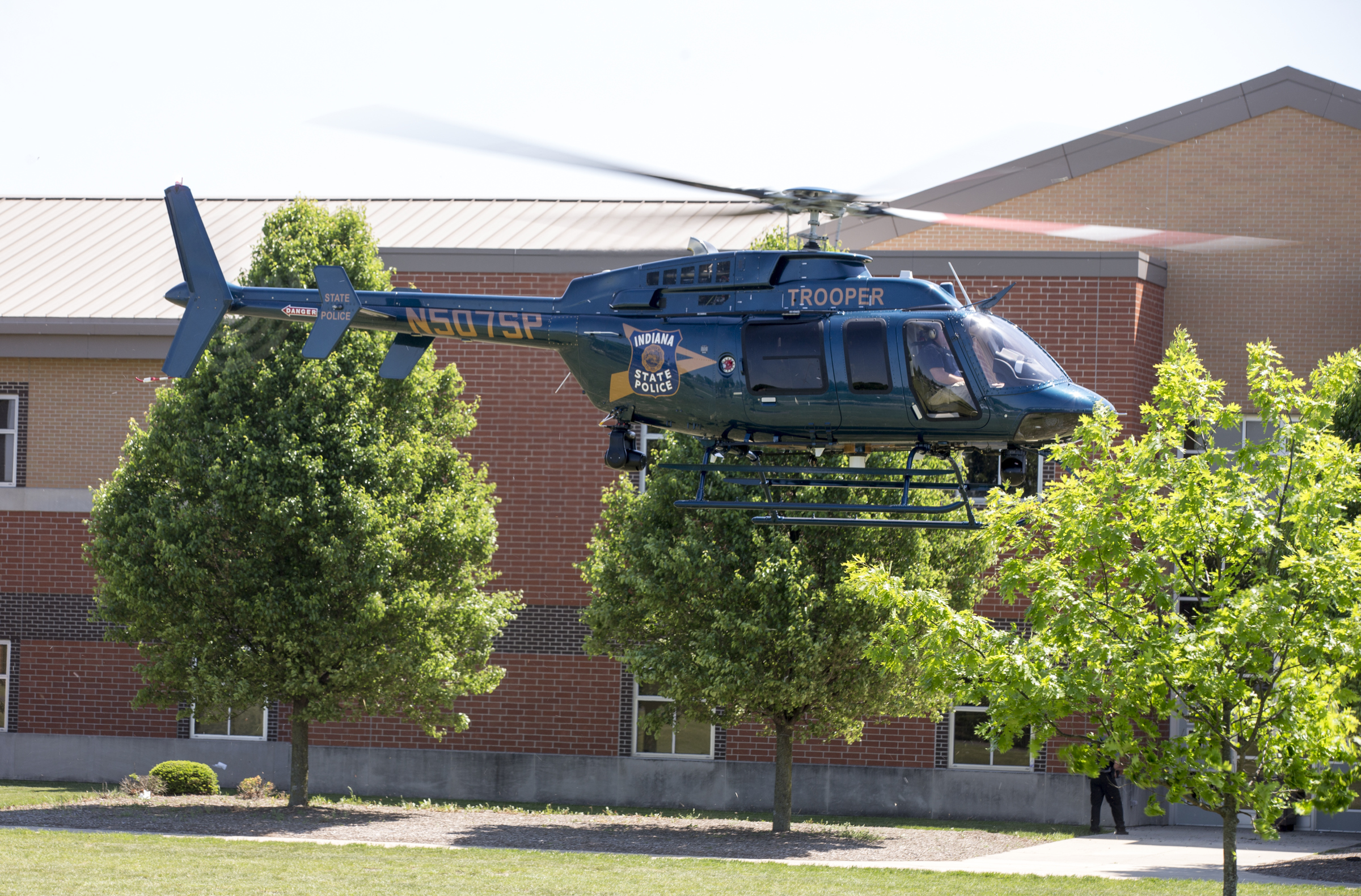 An Indiana State Police helicopter lifts off after a shooting at Noblesville West Middle School in Noblesville, Ind., on Friday, May 25, 2018. A male student opened fire at the suburban Indianapolis school wounding another student and a teacher before being taken into custody, authorities said. (Robert Scheer—AP)