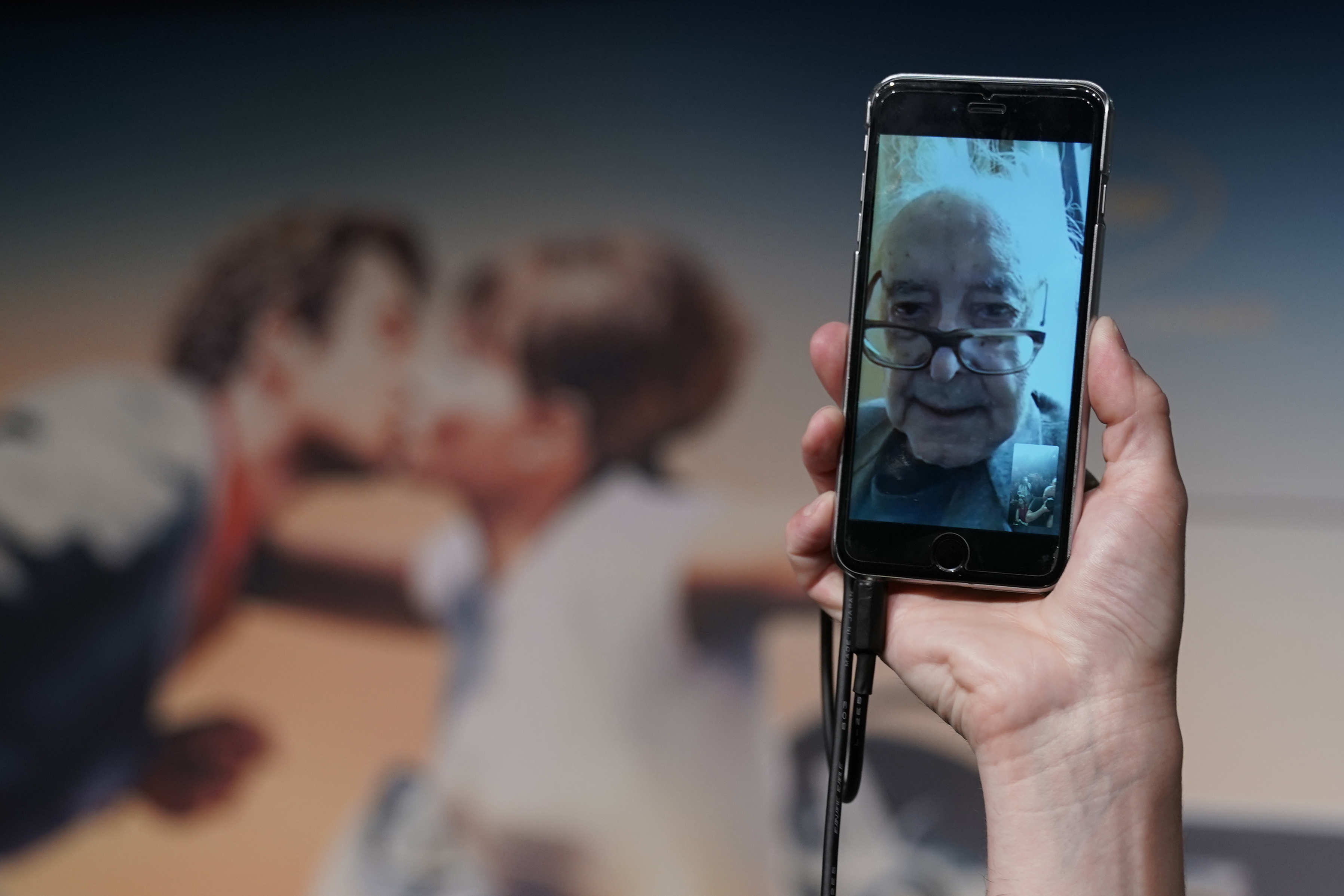 Director Jean-Luc Godard addresses a press conference through a mobile phone video link, from his home in Switzerland, on May 12, 2018 at the 71st Cannes Film Festival in southern France. (LAURENT EMMANUEL&mdash;AFP/Getty Images)