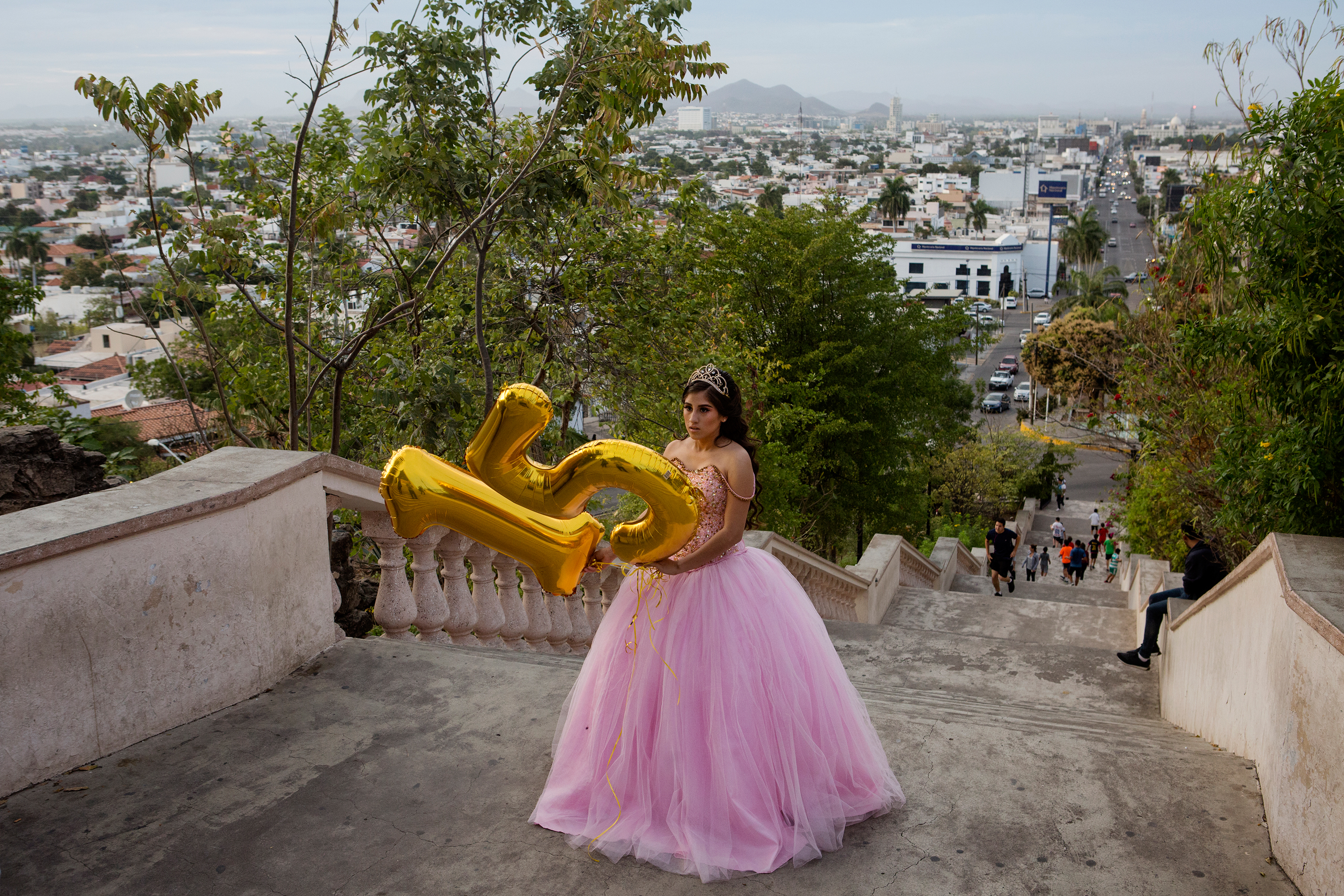 Lacey Carillo Quintera, 15, celebrates her quinceañera by taking photos with her family at the La Lomita overlook in Culiacán, Sinaloa, in February. (Kirsten Luce for TIME)