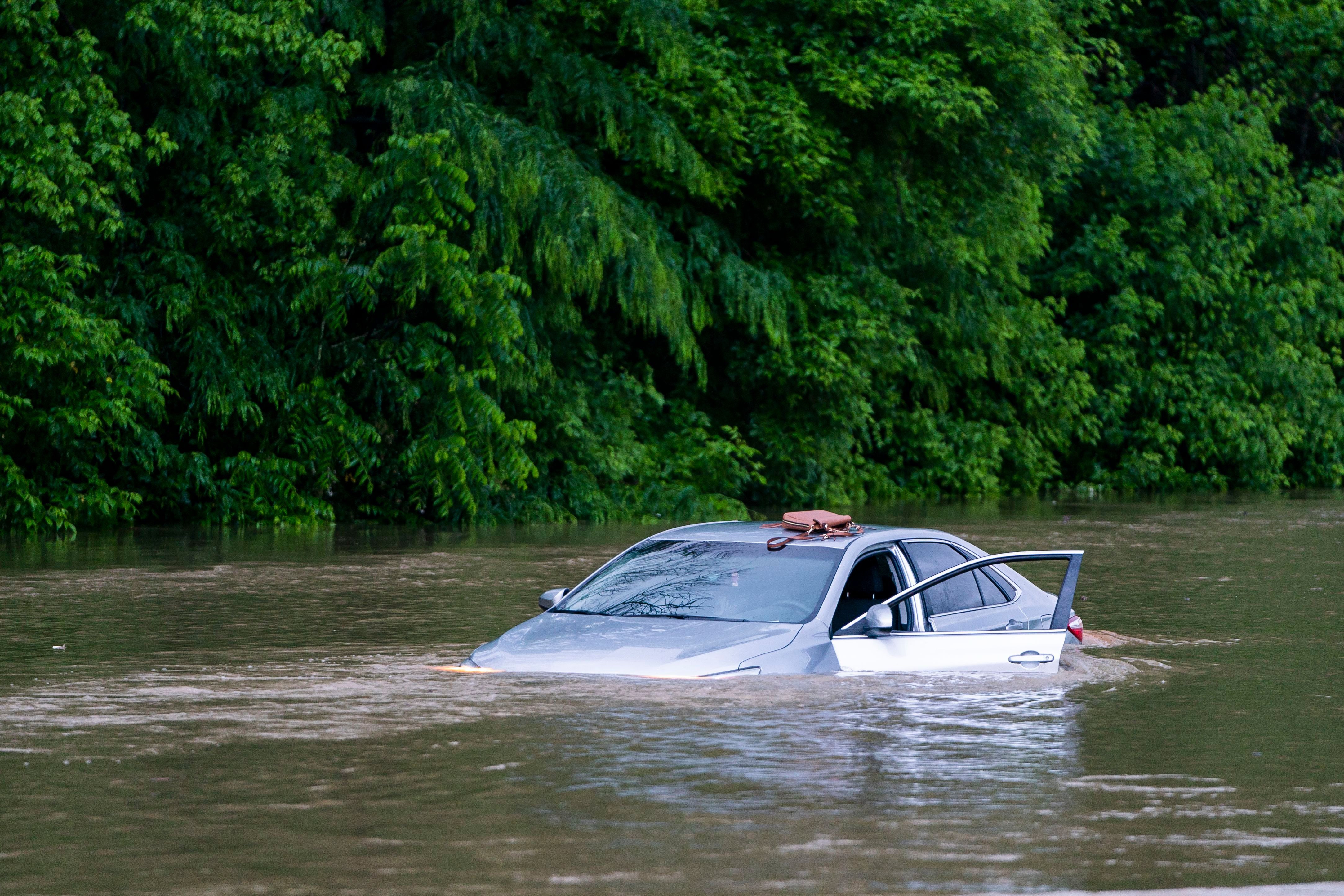 A flooded car on Columbia Pike after a flash flood in Oakland Mills, Maryland, USA, 27 May 2018. The National Weather Service stated as much as 9.5 inches of rain fell in the area. Flash floods ravage Maryland, Oakland Mills, USA - 27 May 2018 (JIM LO SCALZO—EPA-EFE/REX/Shutterstock)