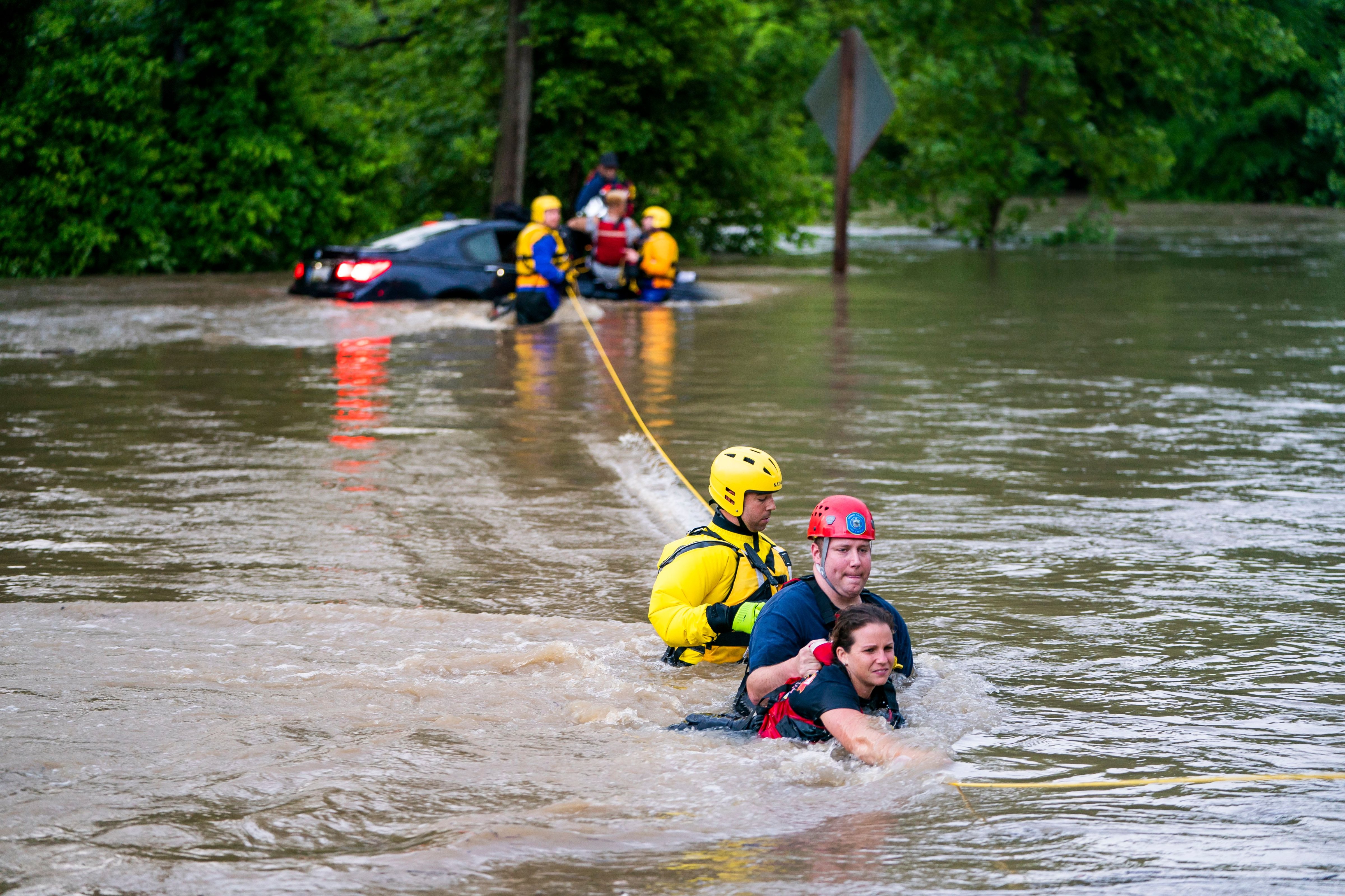 Commuters are rescued from a flooded car on Columbia Pike after a flash flood in Oakland Mills, Maryland, USA, 27 May 2018. The National Weather Service stated as much as 9.5 inches of rain fell in the area. Flash floods ravage Maryland, Oakland Mills, USA - 27 May 2018 (JIM LO SCALZO—EPA-EFE/REX/Shutterstock)