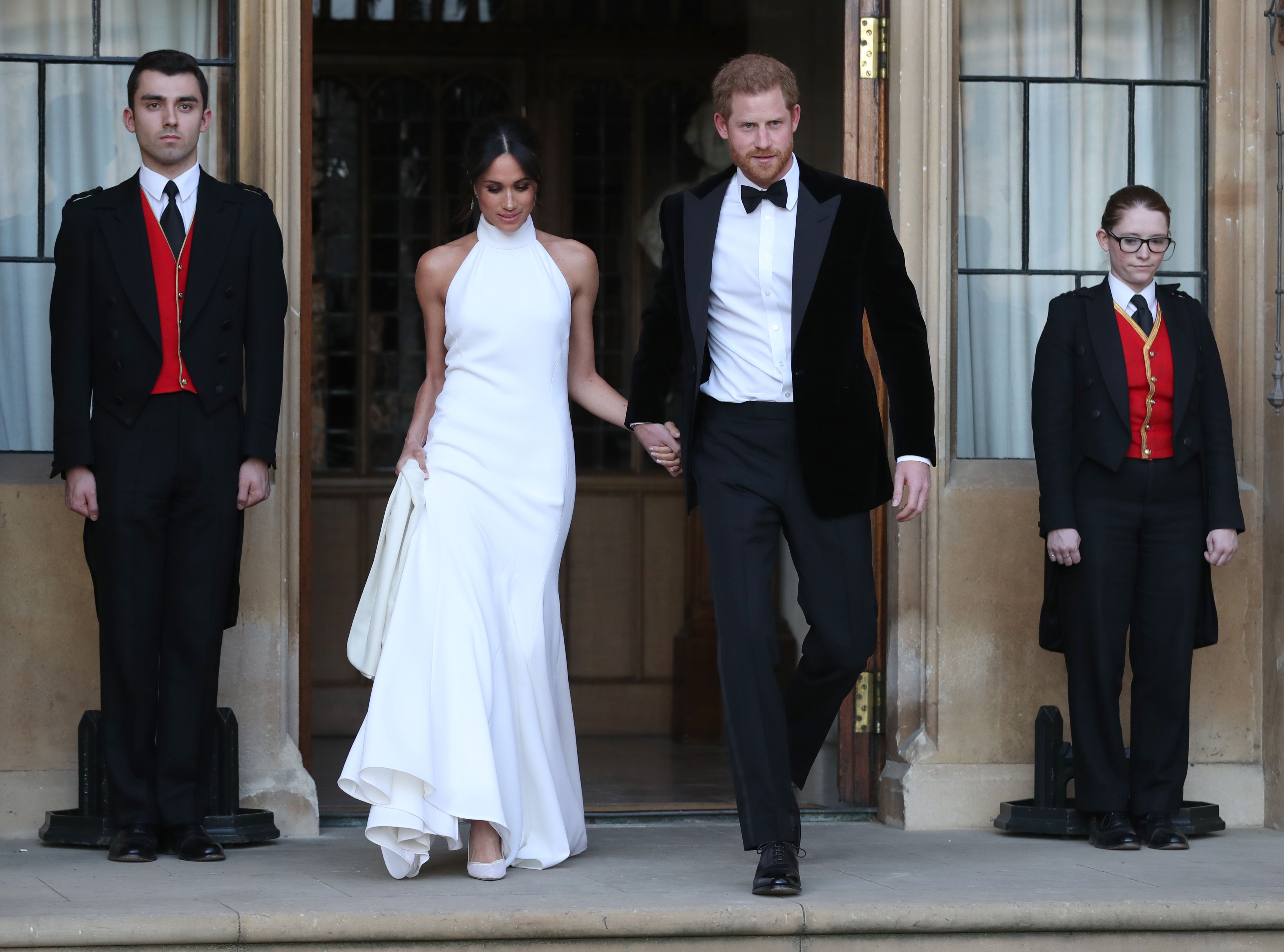 Newly married Meghan Markle, Duchess of Sussex, wears a Stella McCartney wedding reception dress while leaving Windsor Castle in Windsor on May 19, 2018 after their wedding to attend an evening reception at Frogmore House. (STEVE PARSONS—AFP/Getty Images)
