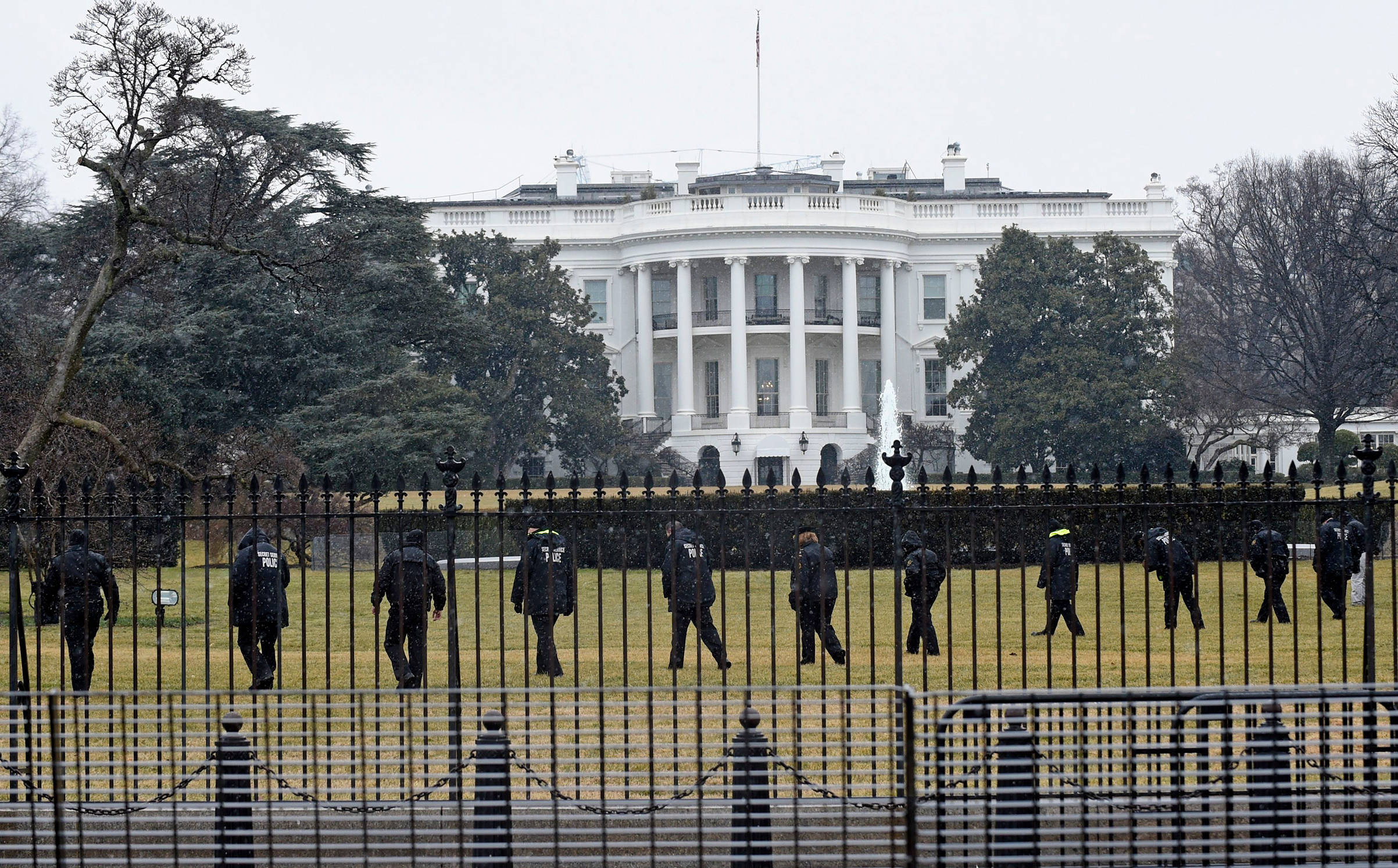Secret Service officers search the south grounds of the White House in Washington, after a device, possibly an unmanned aerial drone, was found on the White House grounds on Jan. 26, 2015. (Susan Walsh—AP/REX/Shutterstock)