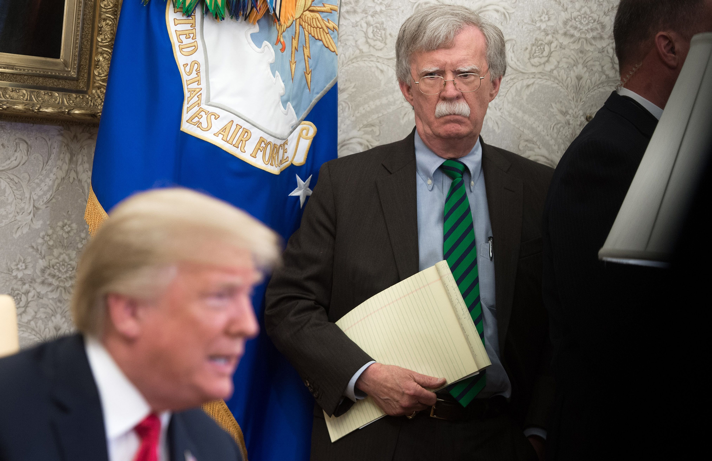 National Security Adviser John Bolton stands alongside US President Donald Trump as he speaks during a meeting with NATO Secretary General Jens Stoltenberg in the Oval Office of the White House in Washington, DC, on May 17, 2018 (SAUL LOEB—AFP/Getty Images)