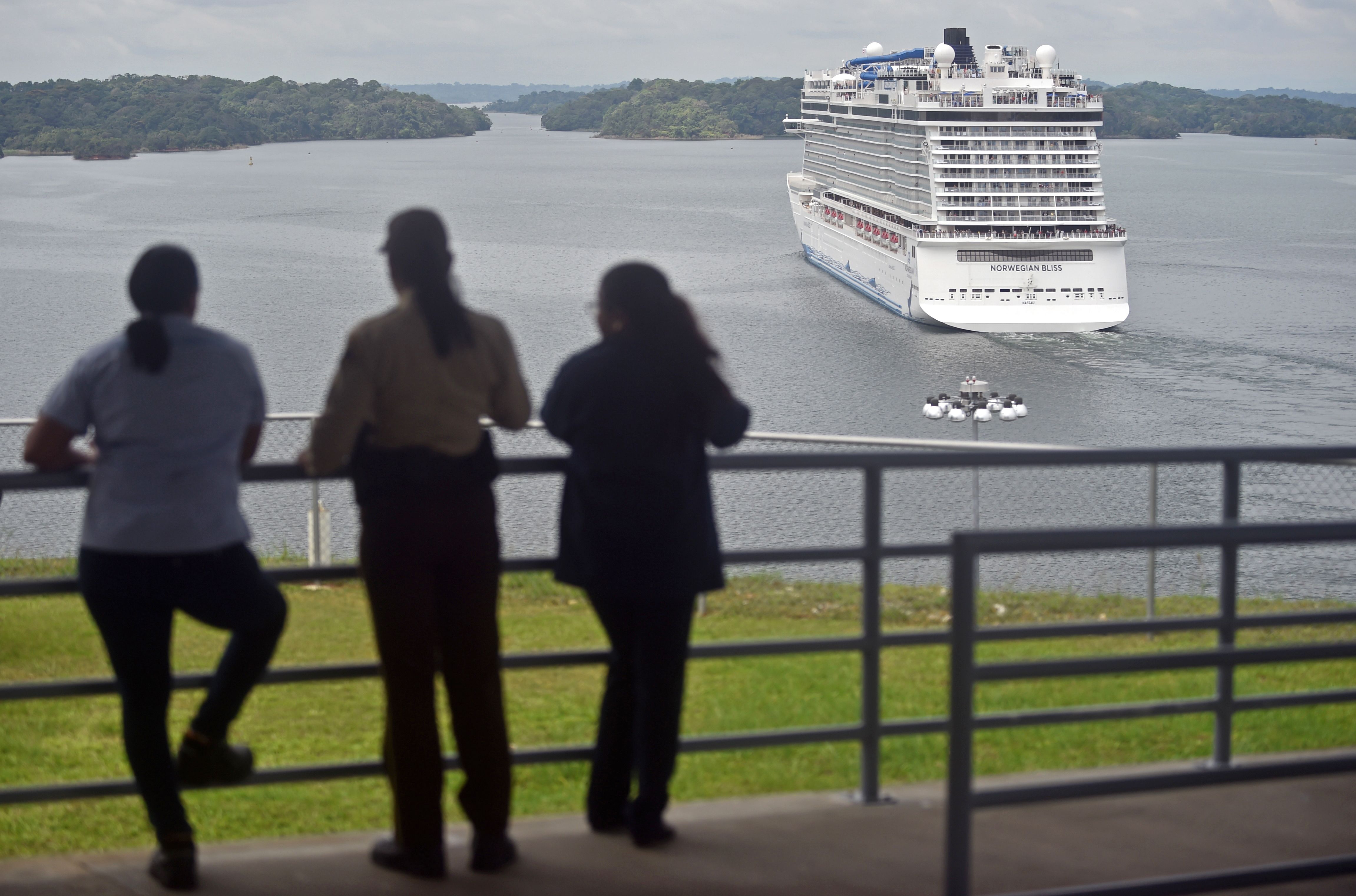 People look at a cruise ship crossing the Panama Canal in the Agua Clara locks in Colon 80 km northwest from Panama City. (RODRIGO ARANGUA—AFP/Getty Images)