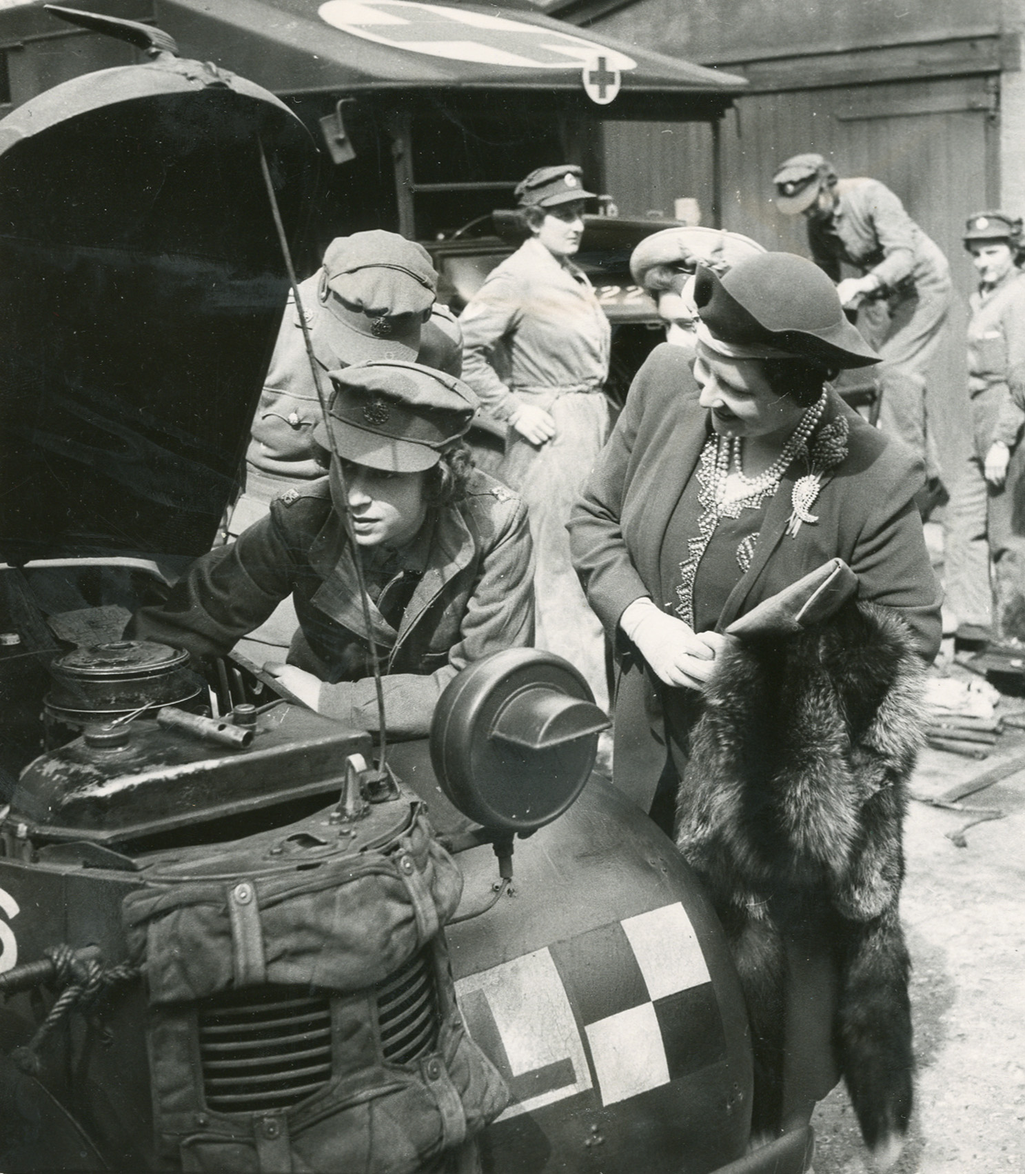 Princess Elizabeth explains to the Queen what she has done to the car engine. April, 1945. (The International Museum of World War II)