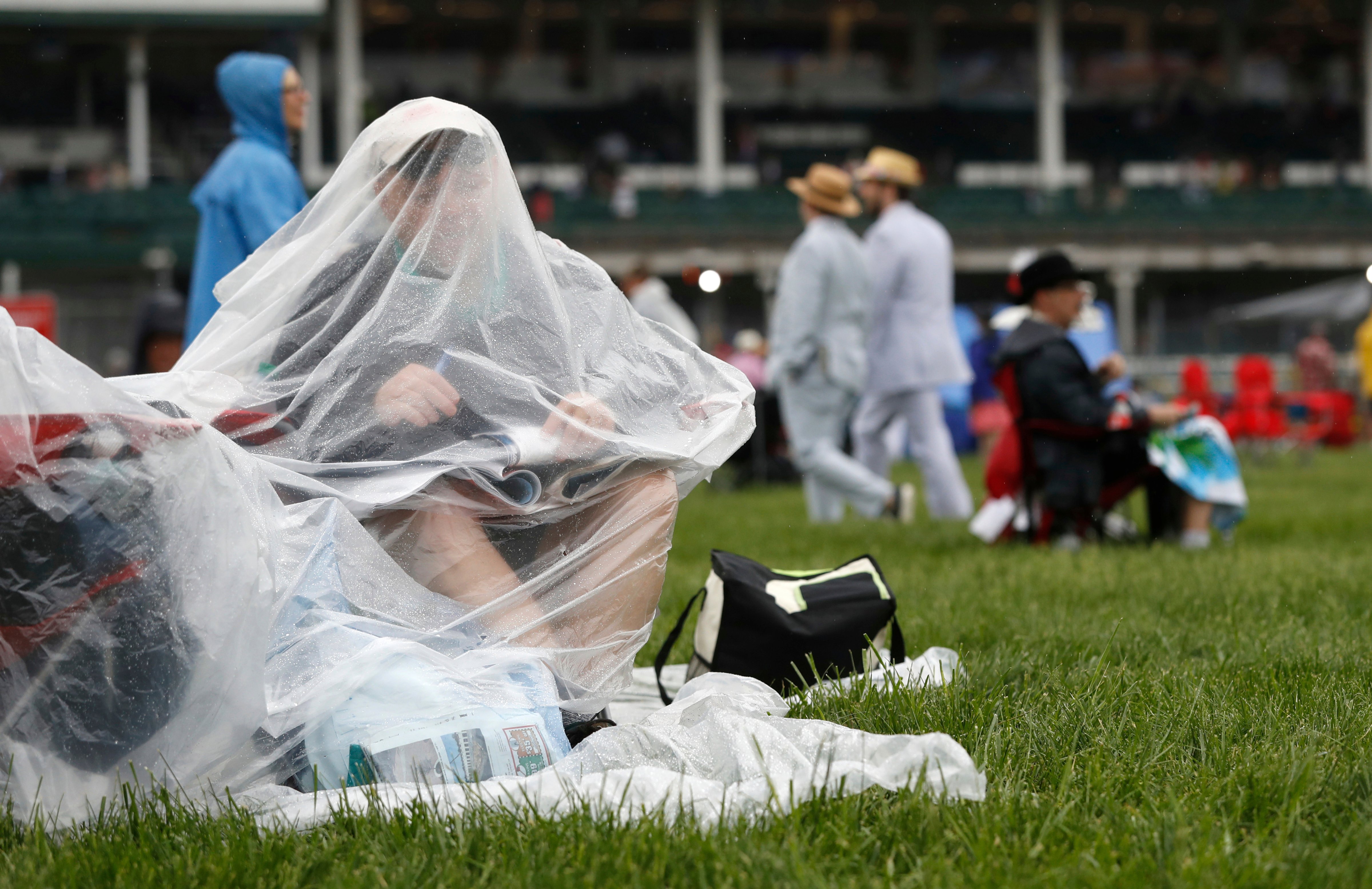 Curt Schuman of Louisville looks at a program before the 144th running of the Kentucky Derby horse race at Churchill Downs, in Louisville, Ky on May 5, 2018 (John Minchillo—AP/REX/Shutterstock)