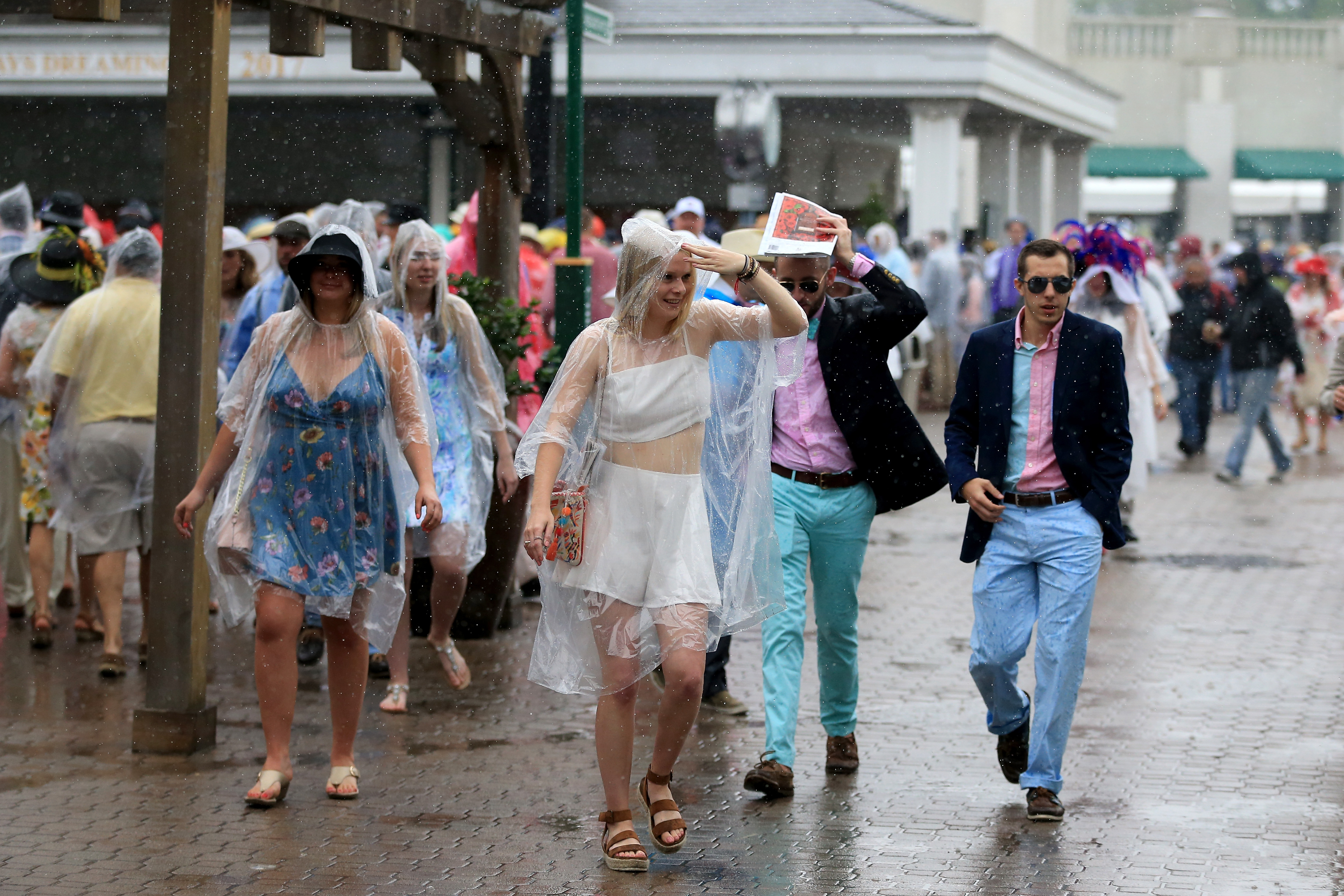 Patrons deal with rain prior to the 144th running of the Kentucky Derby at Churchill Downs on May 5, 2018 in Louisville (Sean M. Haffey—Getty Images)