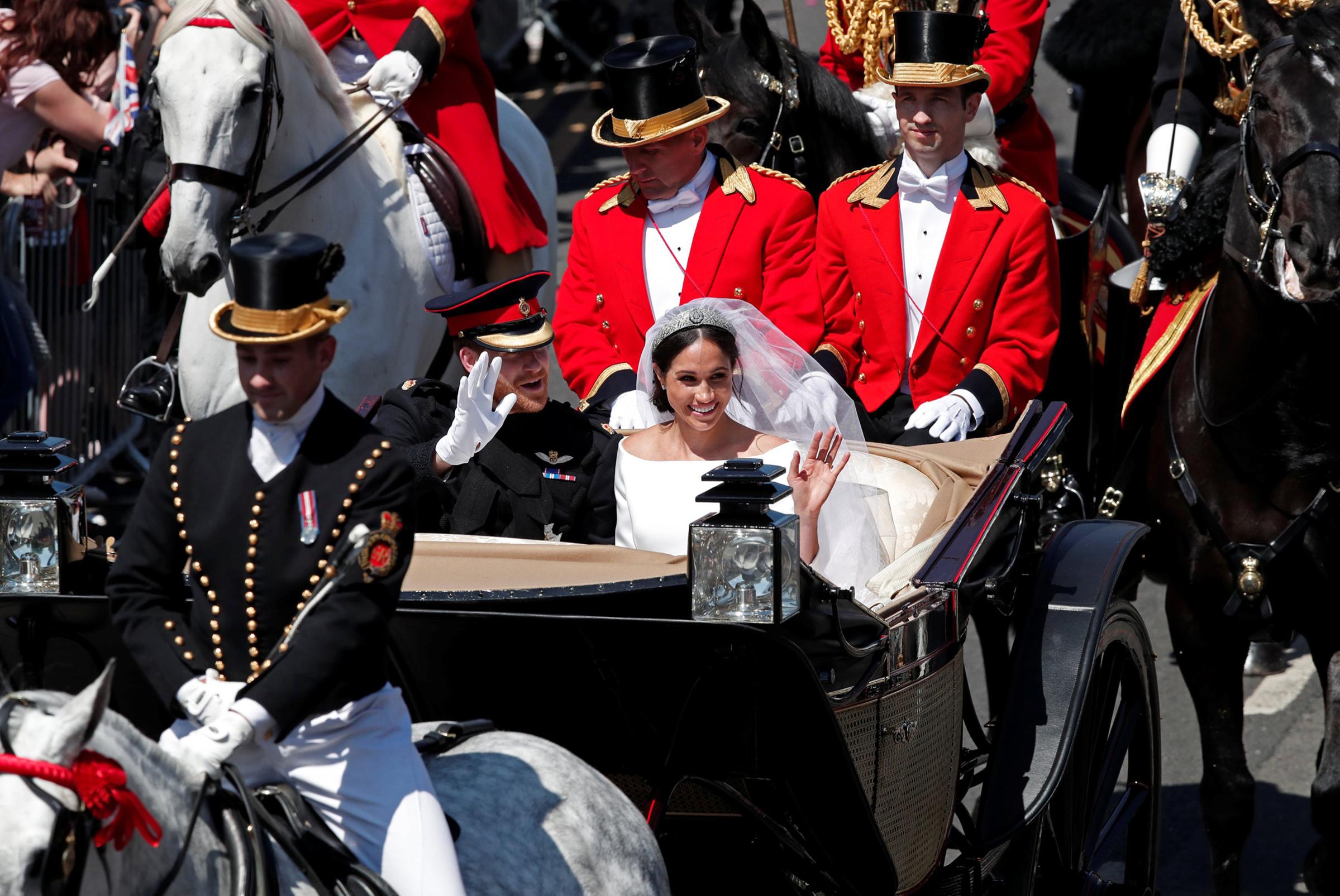 Prince Harry and Meghan Markle in a horse-drawn carriage after their wedding ceremony at St George's Chapel in Windsor Castle, May 19, 2018.