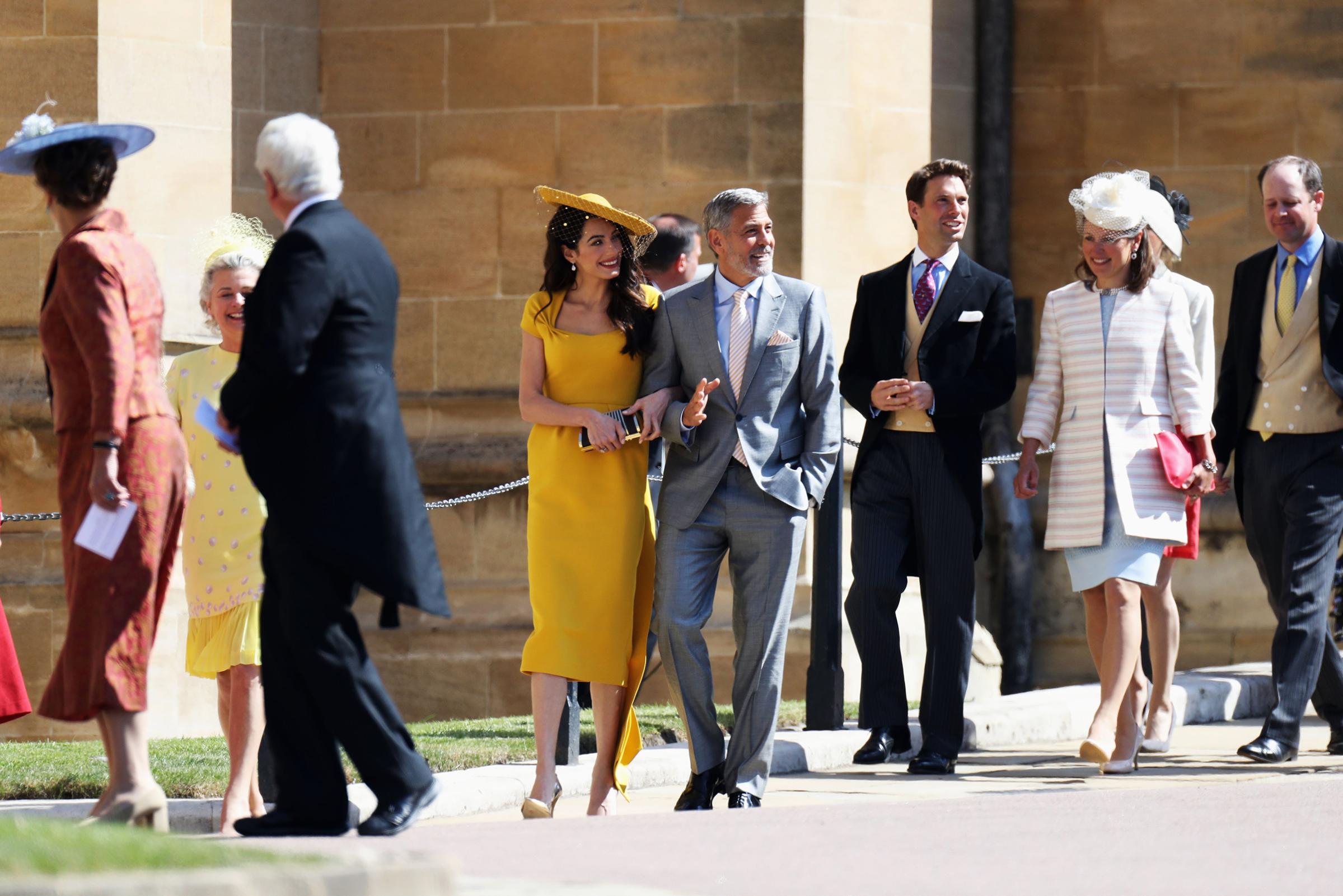 Amal Clooney and George Clooney arrive at the wedding of Prince Harry to Ms Meghan Markle at St George's Chapel, Windsor Castle on May 19, 2018 in Windsor, England.