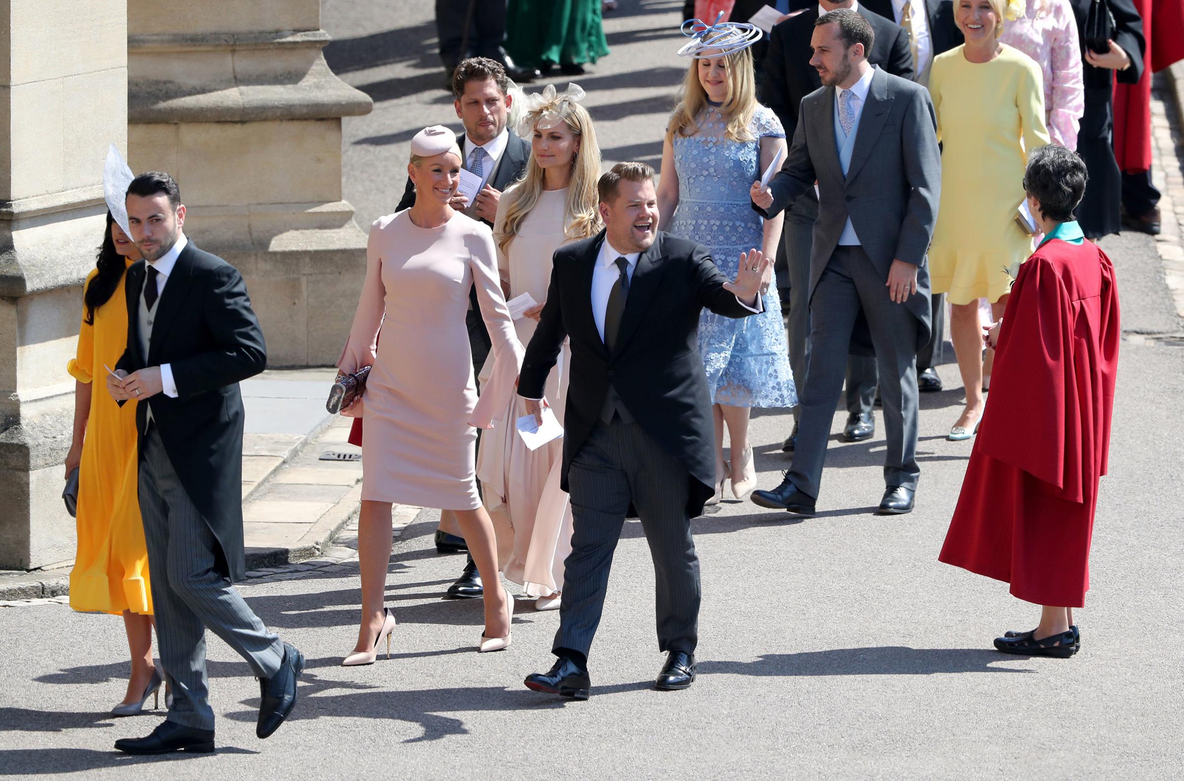 James Corden and Julia Carey arrive for the wedding ceremony of Britain's Prince Harry, Duke of Sussex and Meghan Markle at St George's Chapel, Windsor Castle, in Windsor, on May 19, 2018.