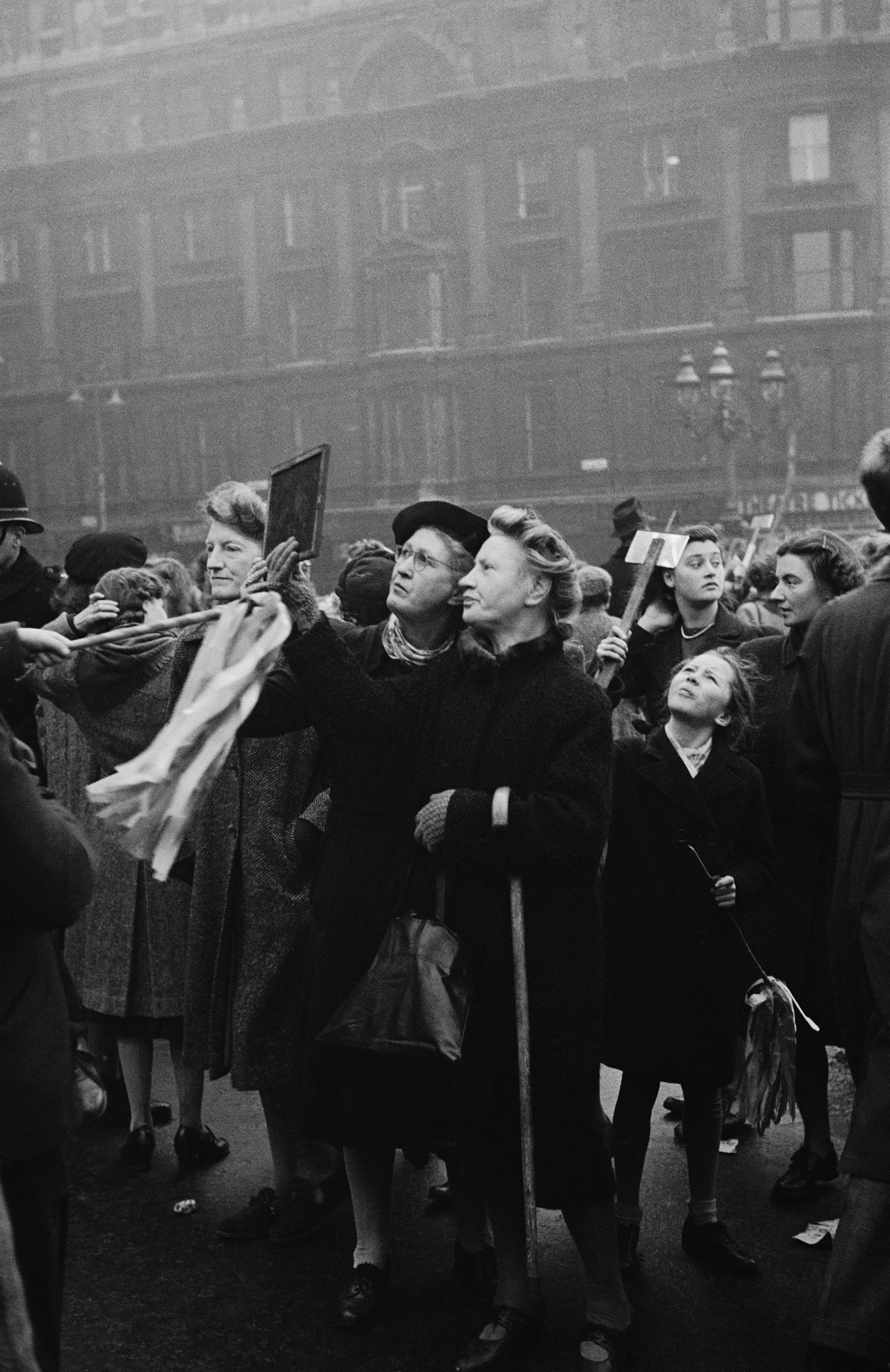 Spectators use hand-held mirrors to see over the crowd during the wedding of Queen Elizabeth II and Prince Philip, Duke of Edinburgh, at Westminster Abbey in London, Nov. 20, 1947.