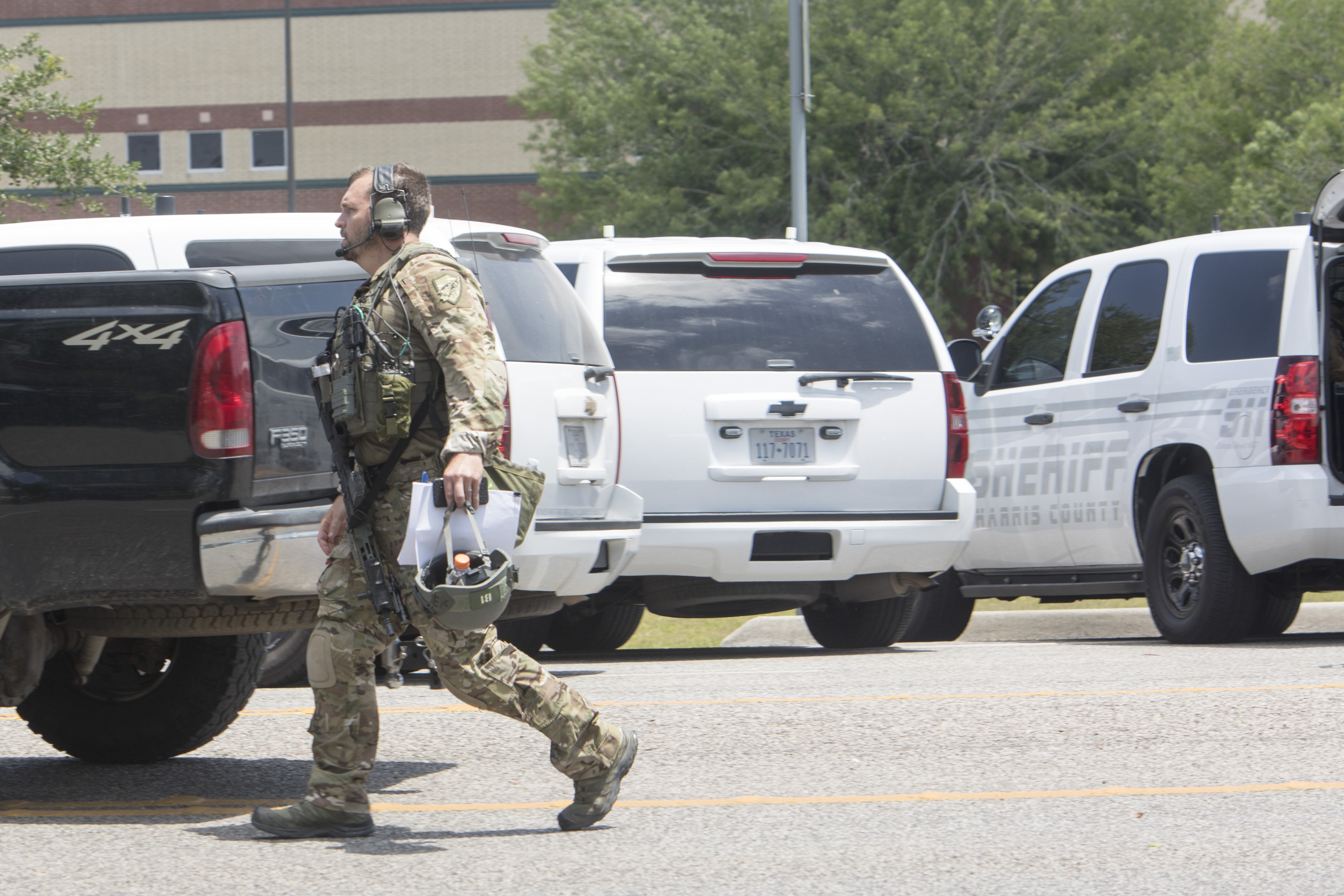 An FBI agent is seen in the parking lot of Santa Fe High School where at least ten people were killed on May 18, 2018 in Santa Fe, Texas. (Daniel Kramer—AFP/Getty Images)