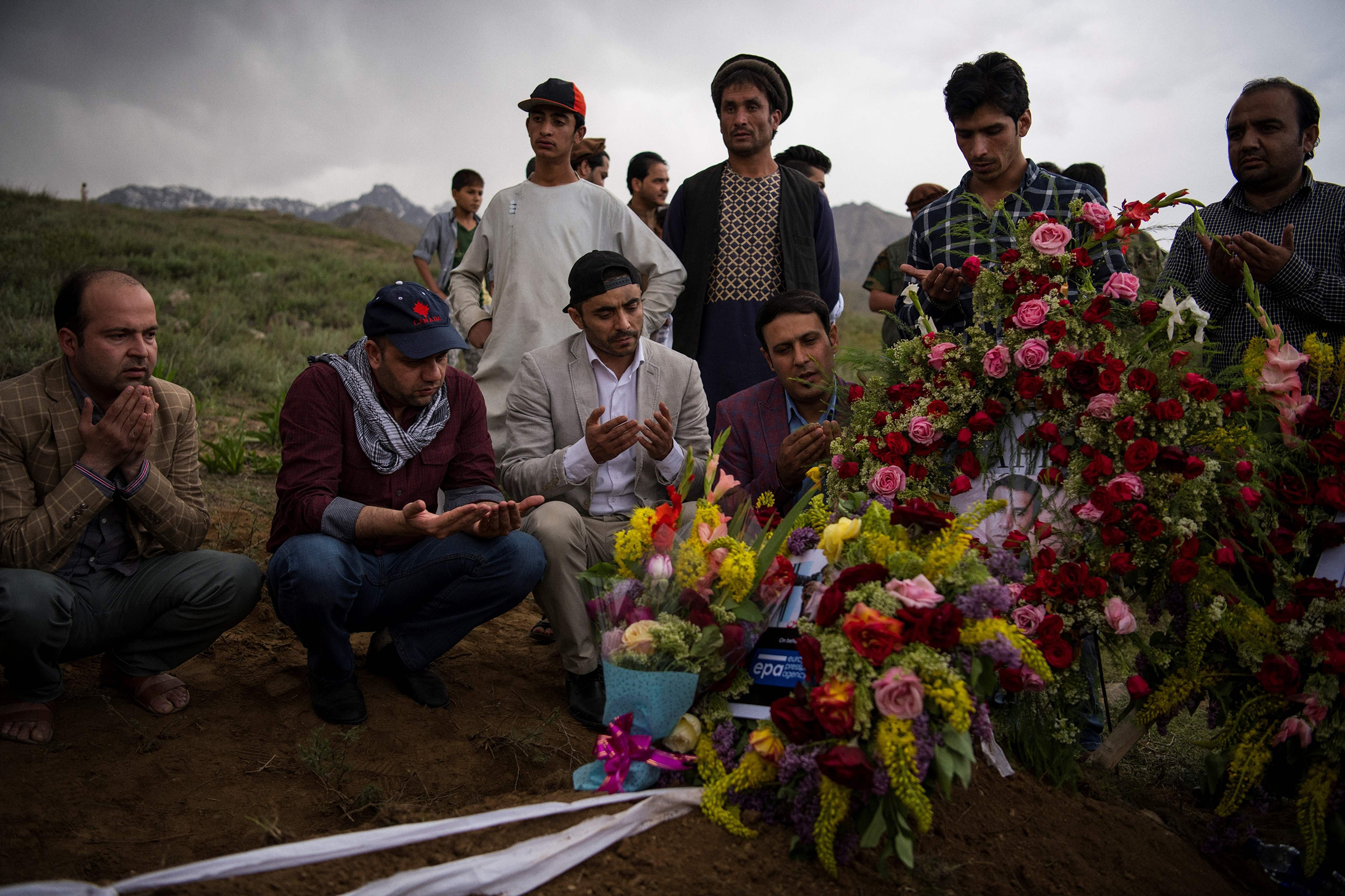 Friends and relatives of Marai at his grave in the village of Guldara (Andrew Quilty—AFP/Getty Images)
