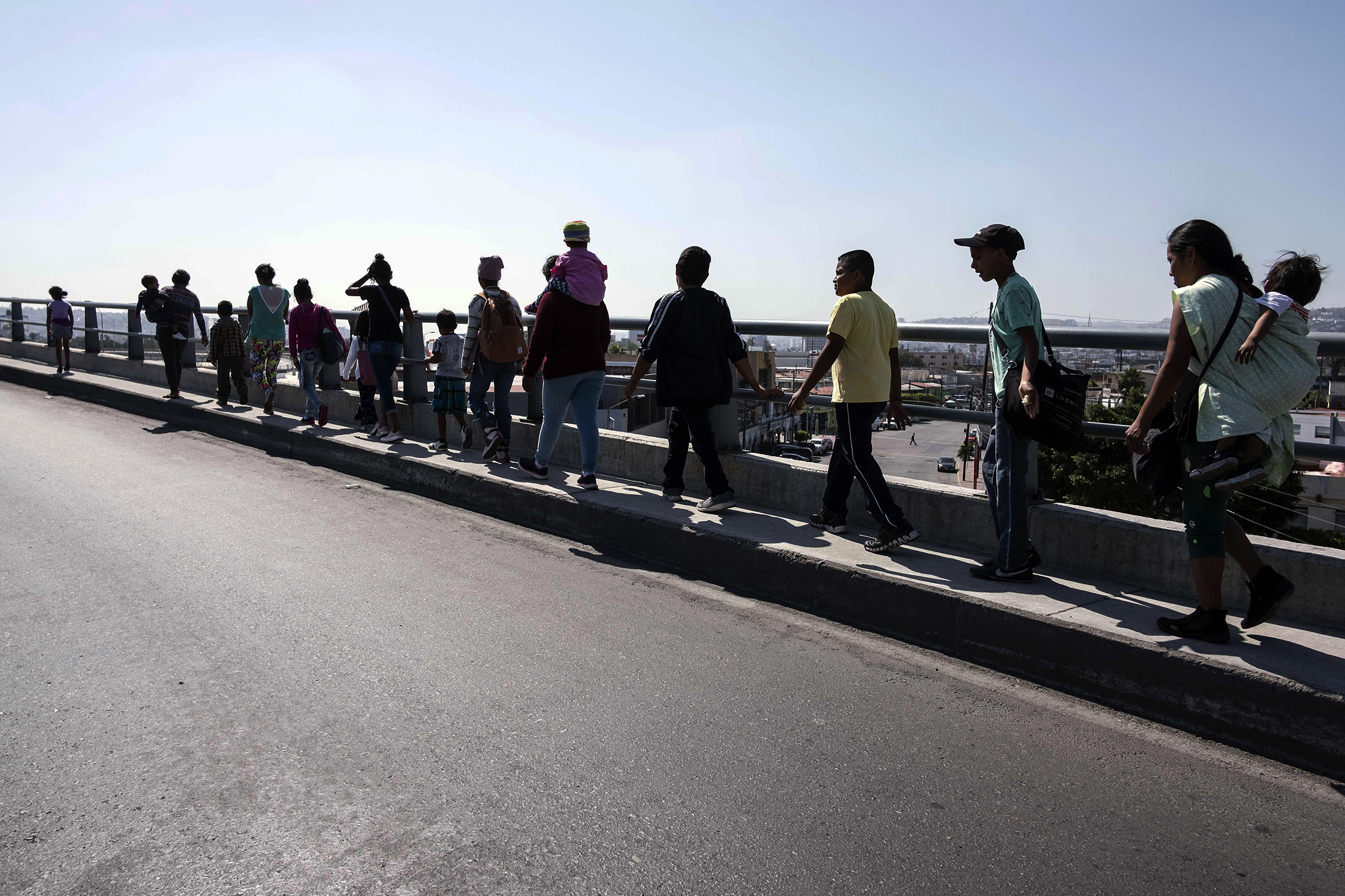 Central American migrants travelling in the "Migrant Via Crucis" caravan walk to their legal counselling meeting in Tijuana, Baja California state, Mexico, on April 28, 2018 (GUILLERMO ARIAS—AFP/Getty Images)