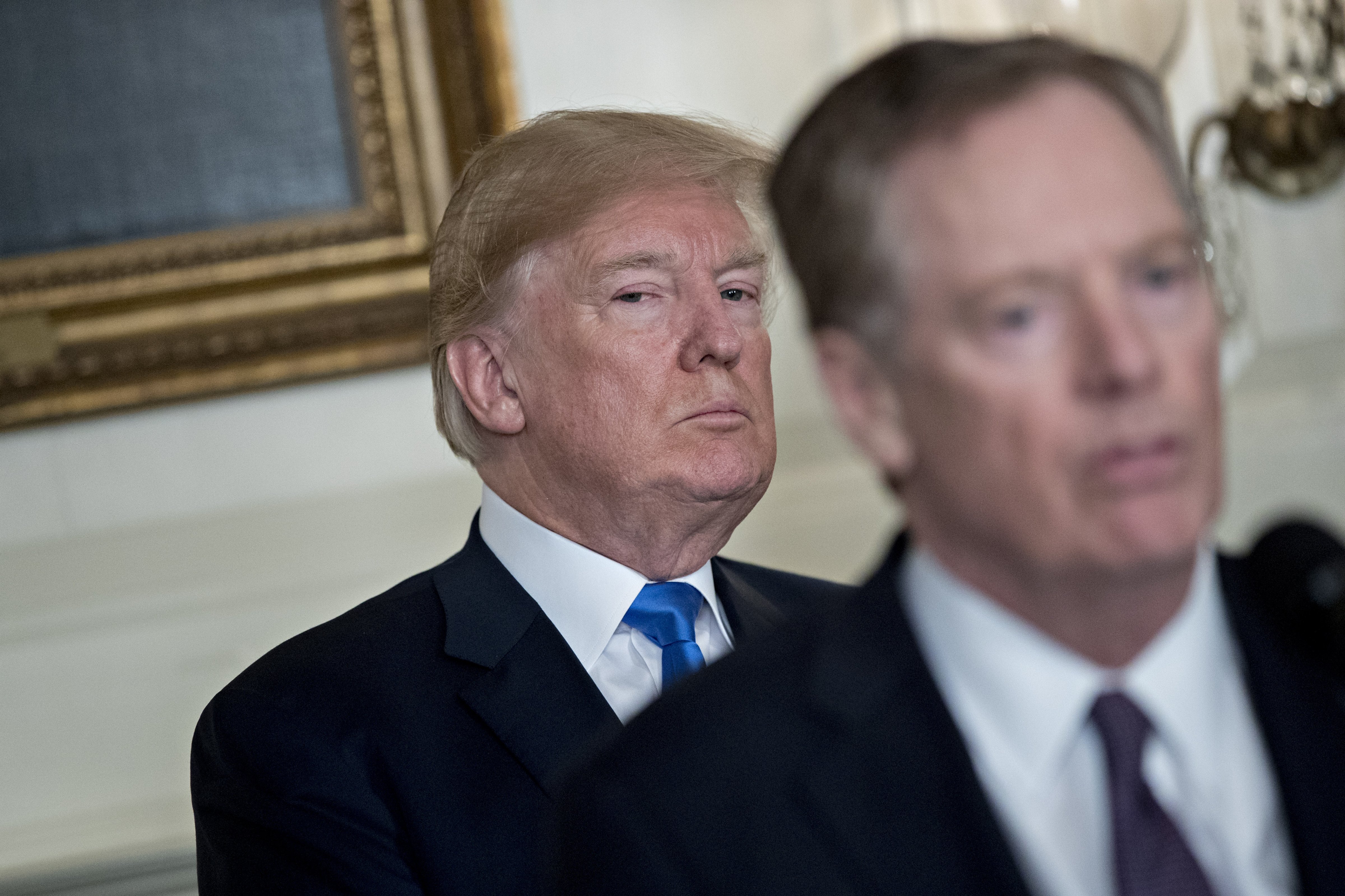 U.S. President Donald Trump listens as Robert Lighthizer, U.S. trade representative, right, speaks before Trump signs a presidential memorandum targeting China's economic aggression in the Diplomatic Room of the White House in Washington, D.C. on March 22 (Bloomberg—Bloomberg via Getty Images)