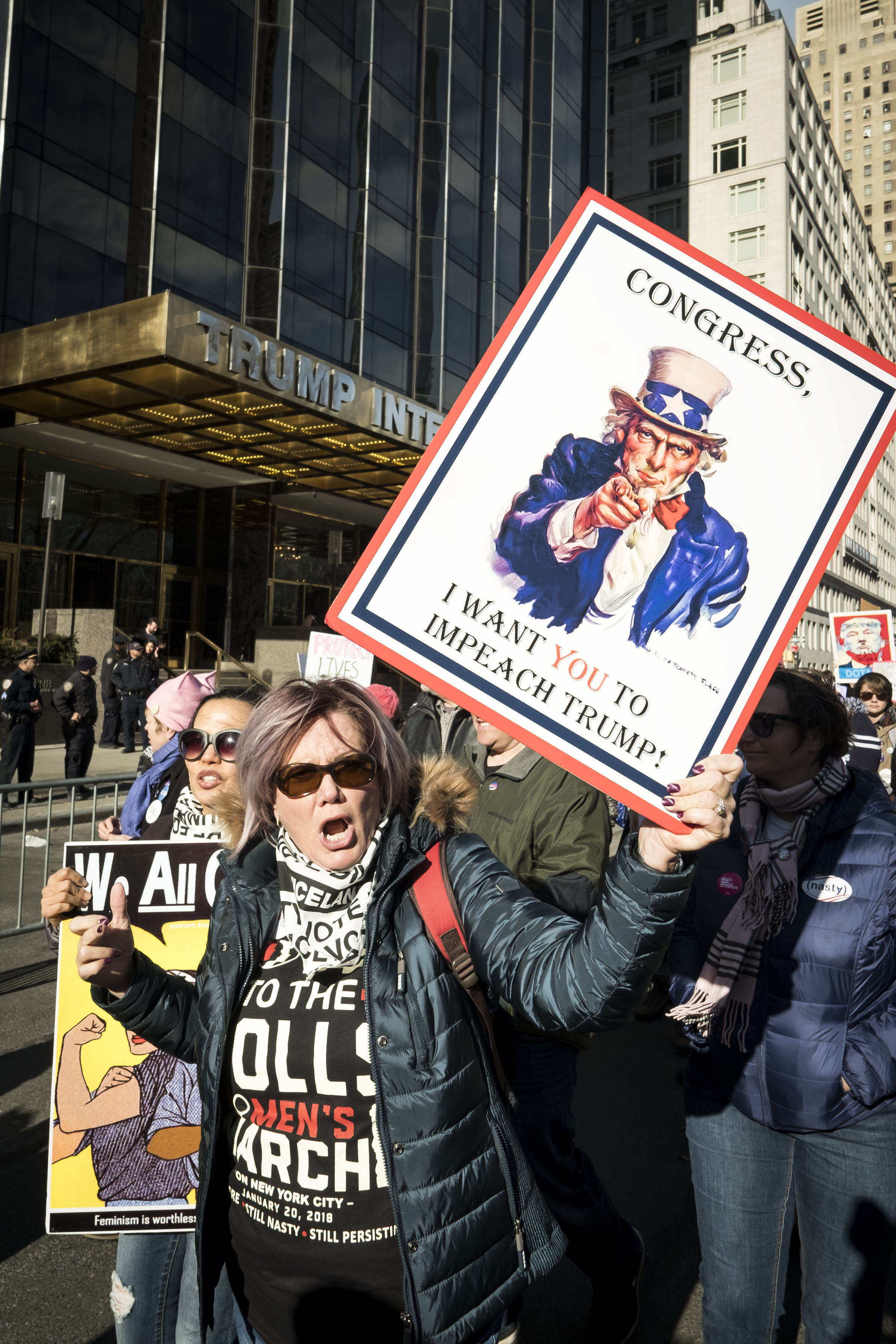 NEW YORK, NY - JANUARY 20: A demonstrator holds up a  banner saying "Congress, I Want You To Impeach Trump" in front of Trump International Hotel and Tower during the second annual Women's March in the borough of Manhattan in New York City, U.S. on Saturday, January 20, 2018. (Ira L. Black - Corbis&mdash;Corbis via Getty Images)