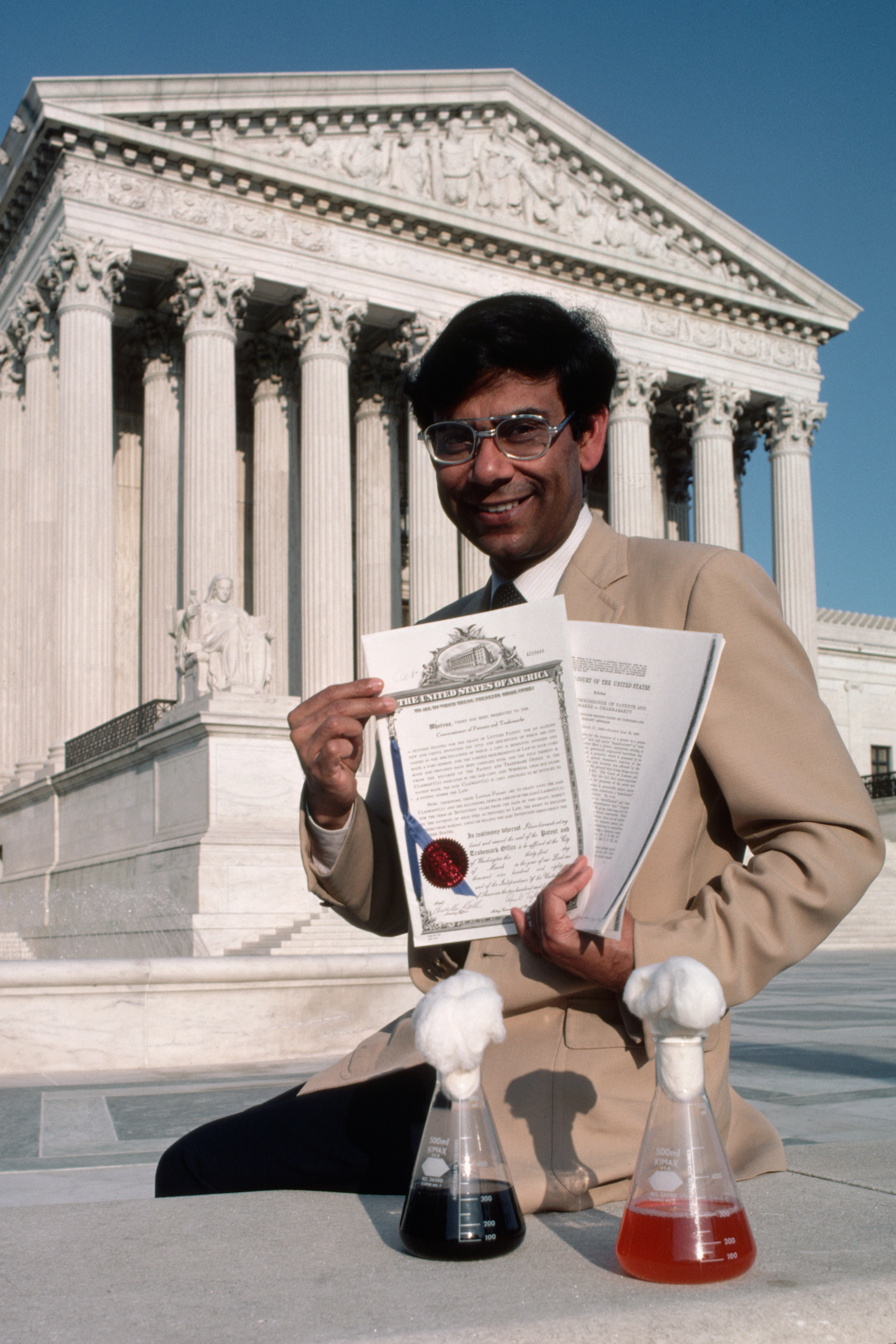 In front of the Supreme Court of the United States, Dr. Ananda Chakrabarty displays a trio of souvenirs of his pioneering experiments with a recombinant DNA created oil spill-eating bacteria. (Ted Spiegel—Corbis/Getty Images)