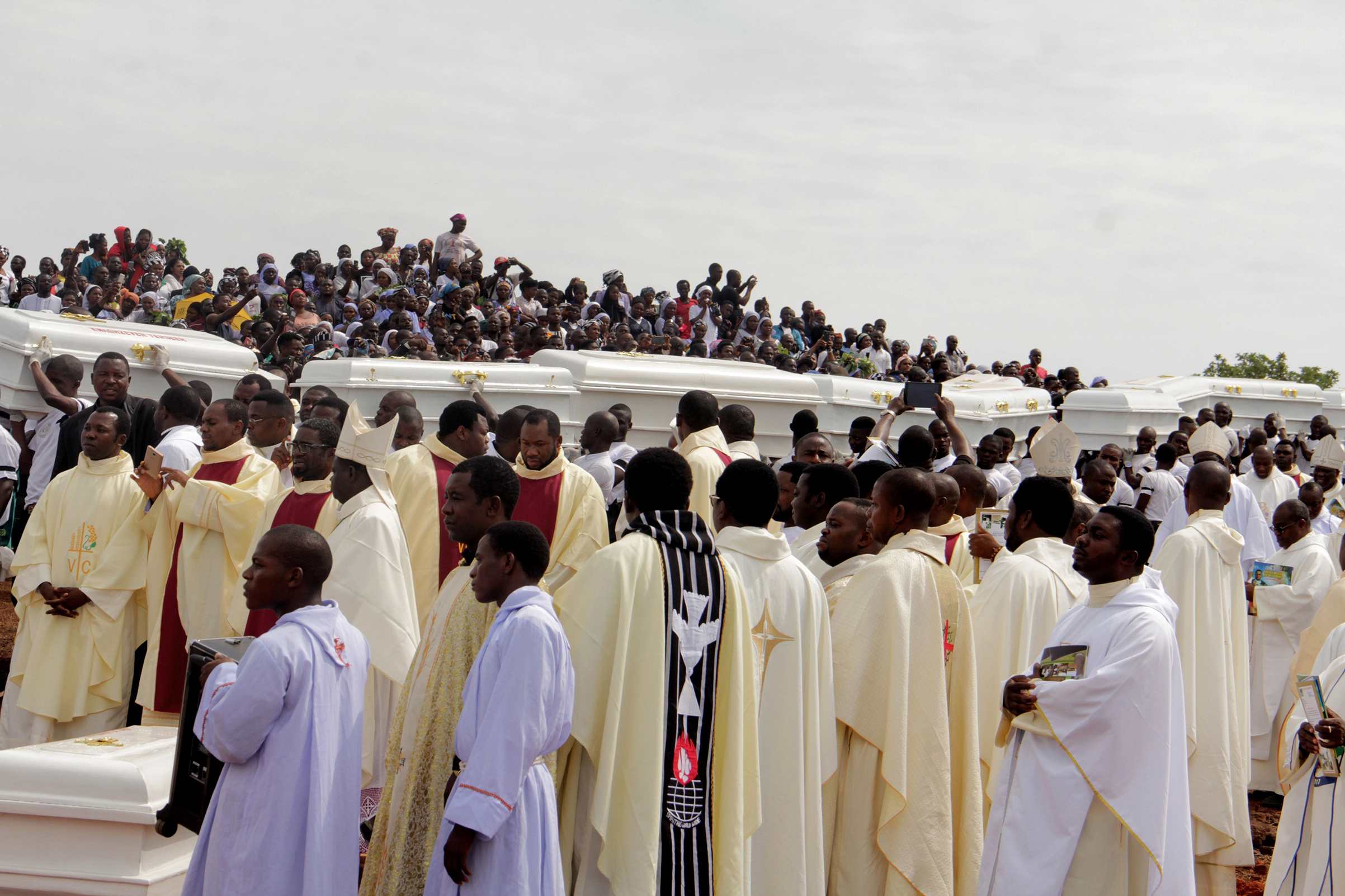 Coffins at a funeral service on May 22 for 17 worshippers and two priests who were allegedly killed by Fulani herdsmen in central Benue State, Nigeria; the region has suffered a wave of deadly unrest. (Emmy Ibu—AFP/Getty Images)