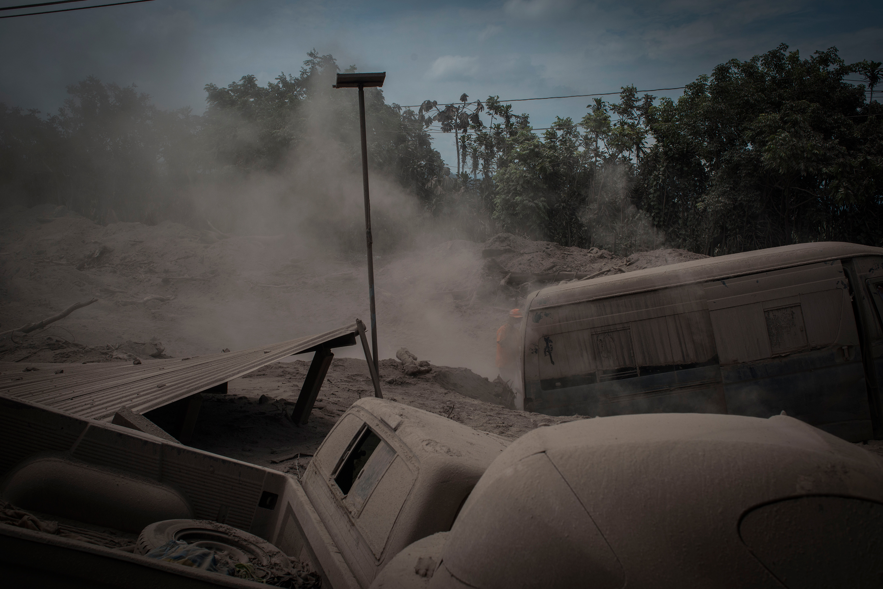 Ash-covered vehicles, destroyed in the eruption, in San Miguel Los Lotes on June 5. (Daniele Volpe)